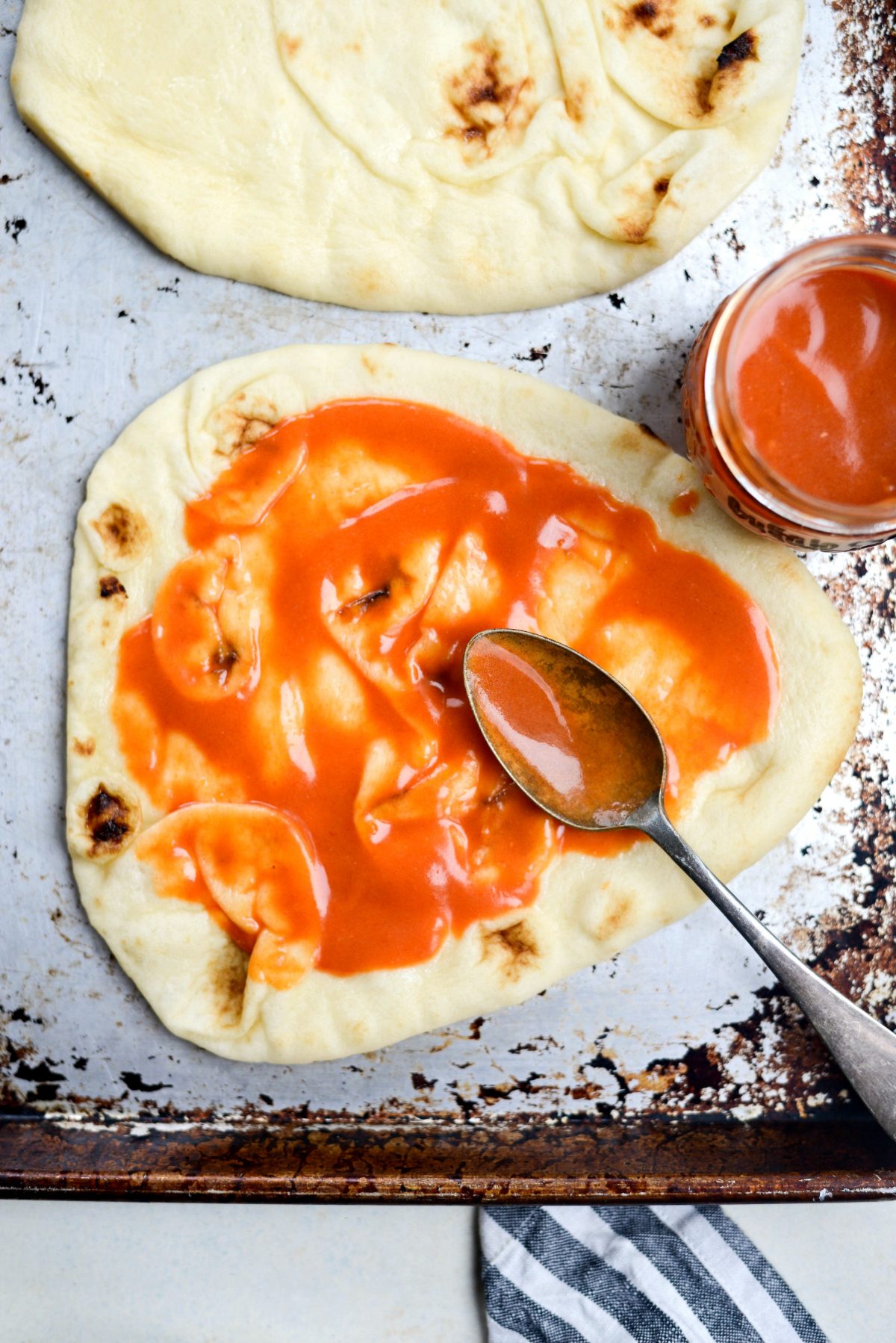 naan spread with buffalo sauce.