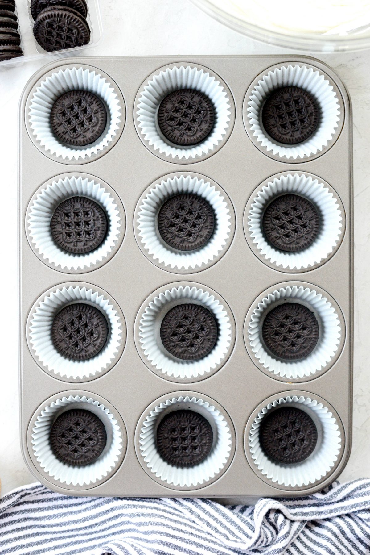 cookies in the bottom of muffin liners in muffin pan.