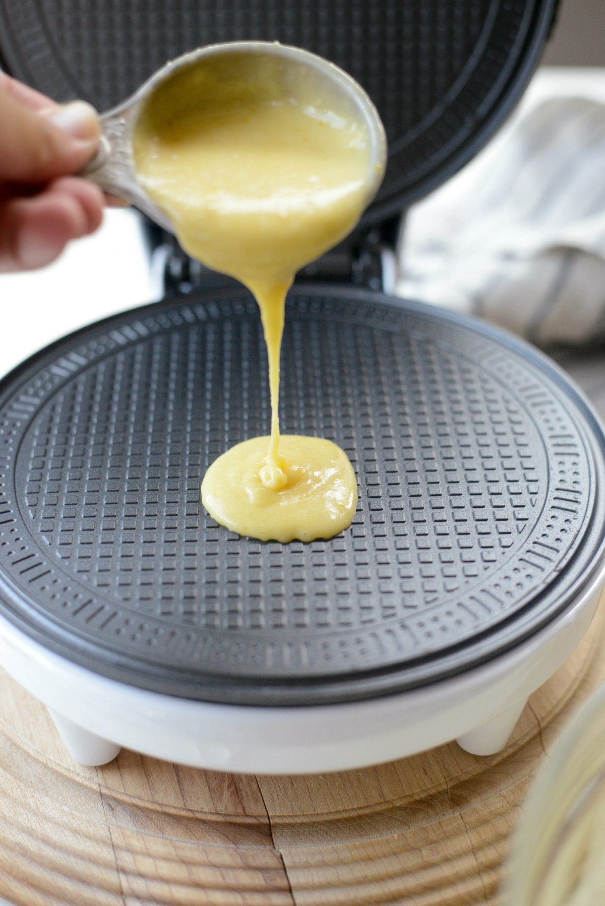 pouring batter onto waffle bowl/cone maker