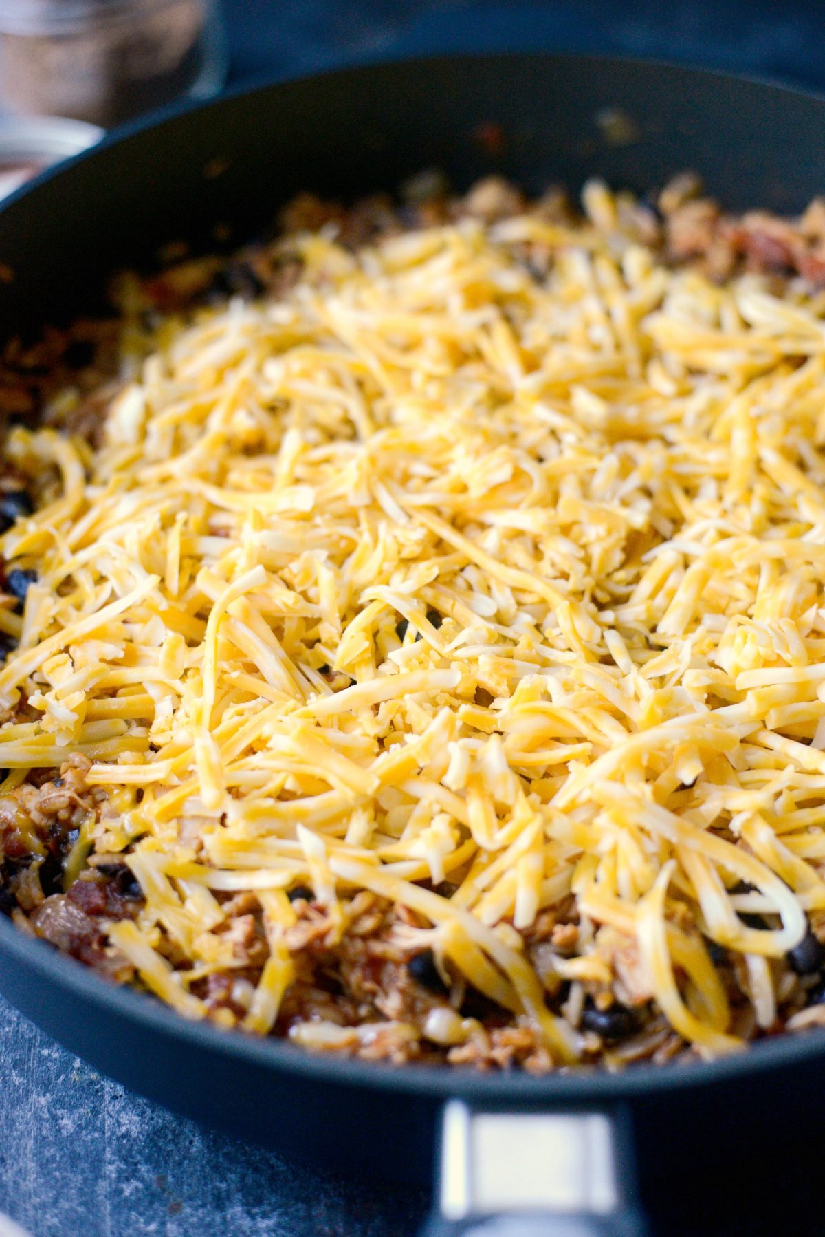 top with shredded cheese, cover until melted.