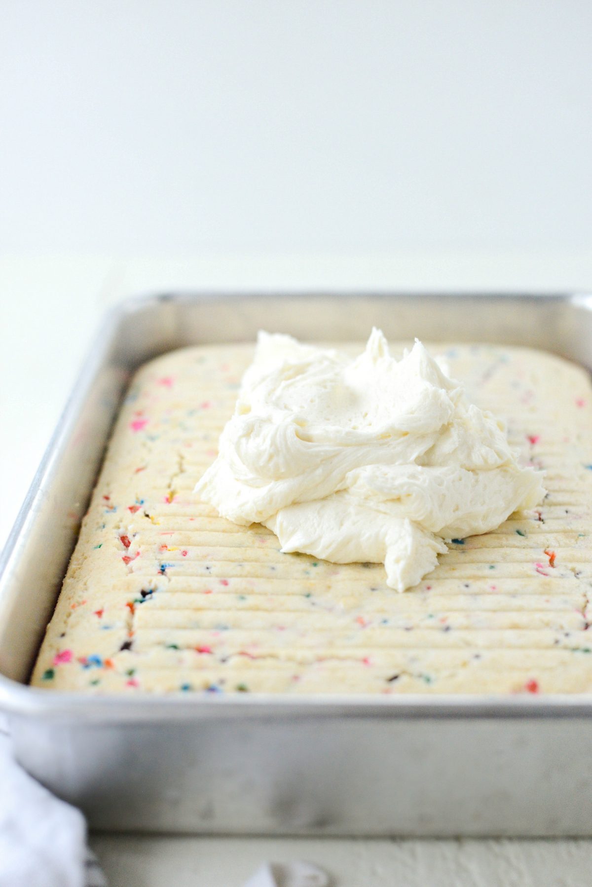dollop of frosting on top of cake