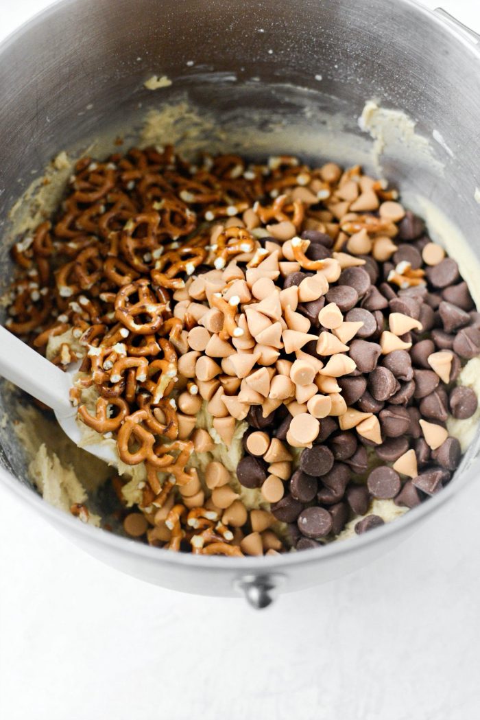 add in chocolate and butterscotch chips and pretzels