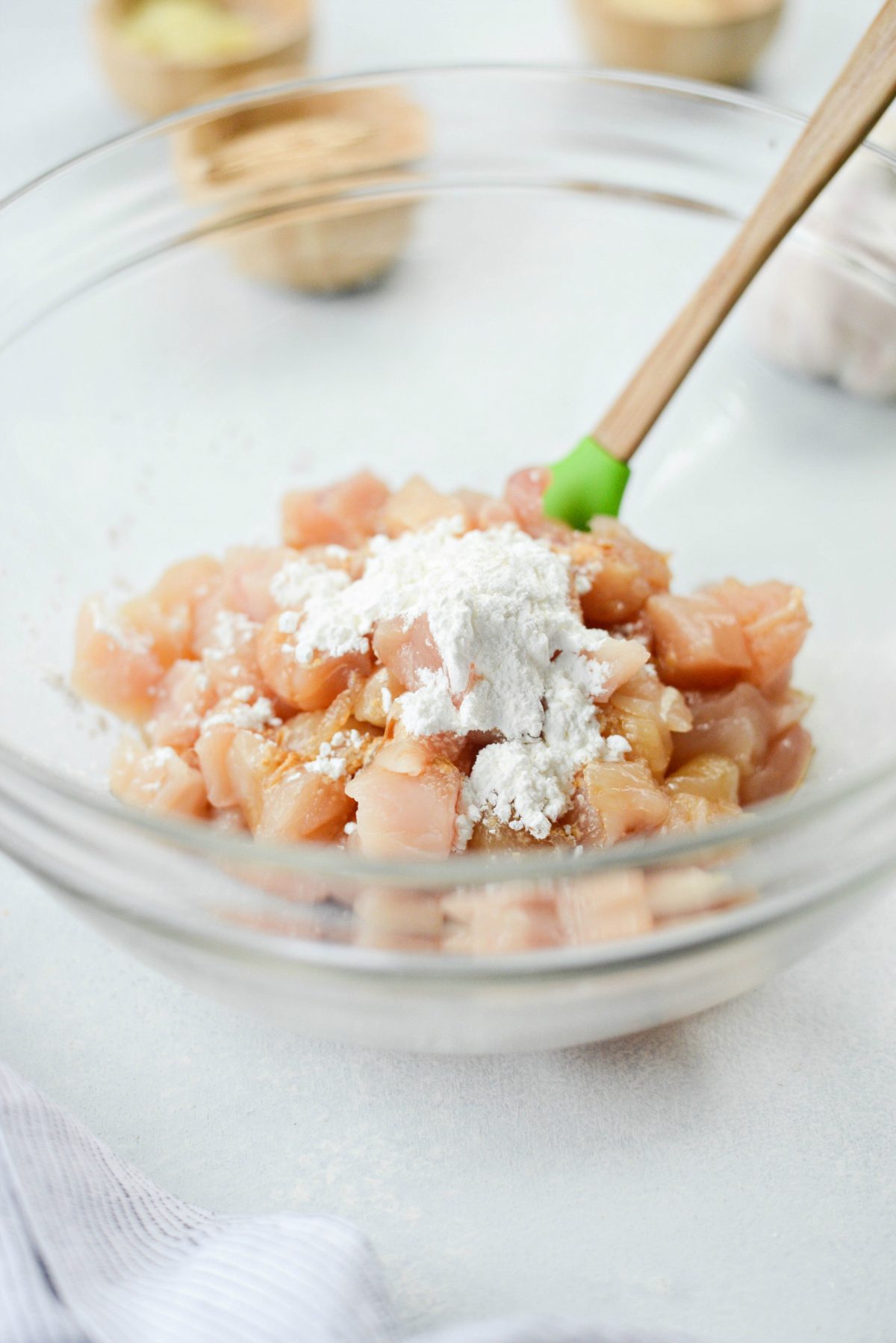 diced chicken tenders, tamari, white pepper and cornstarch in a bowl.