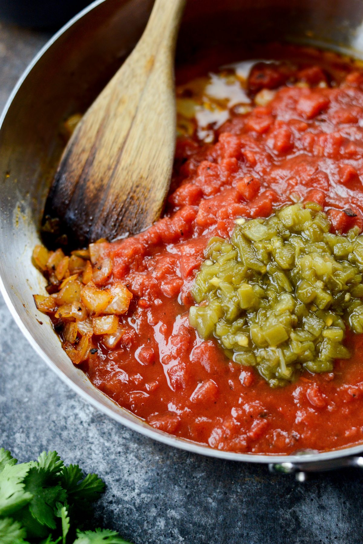add crushed fire-roasted tomatoes and diced green chiles