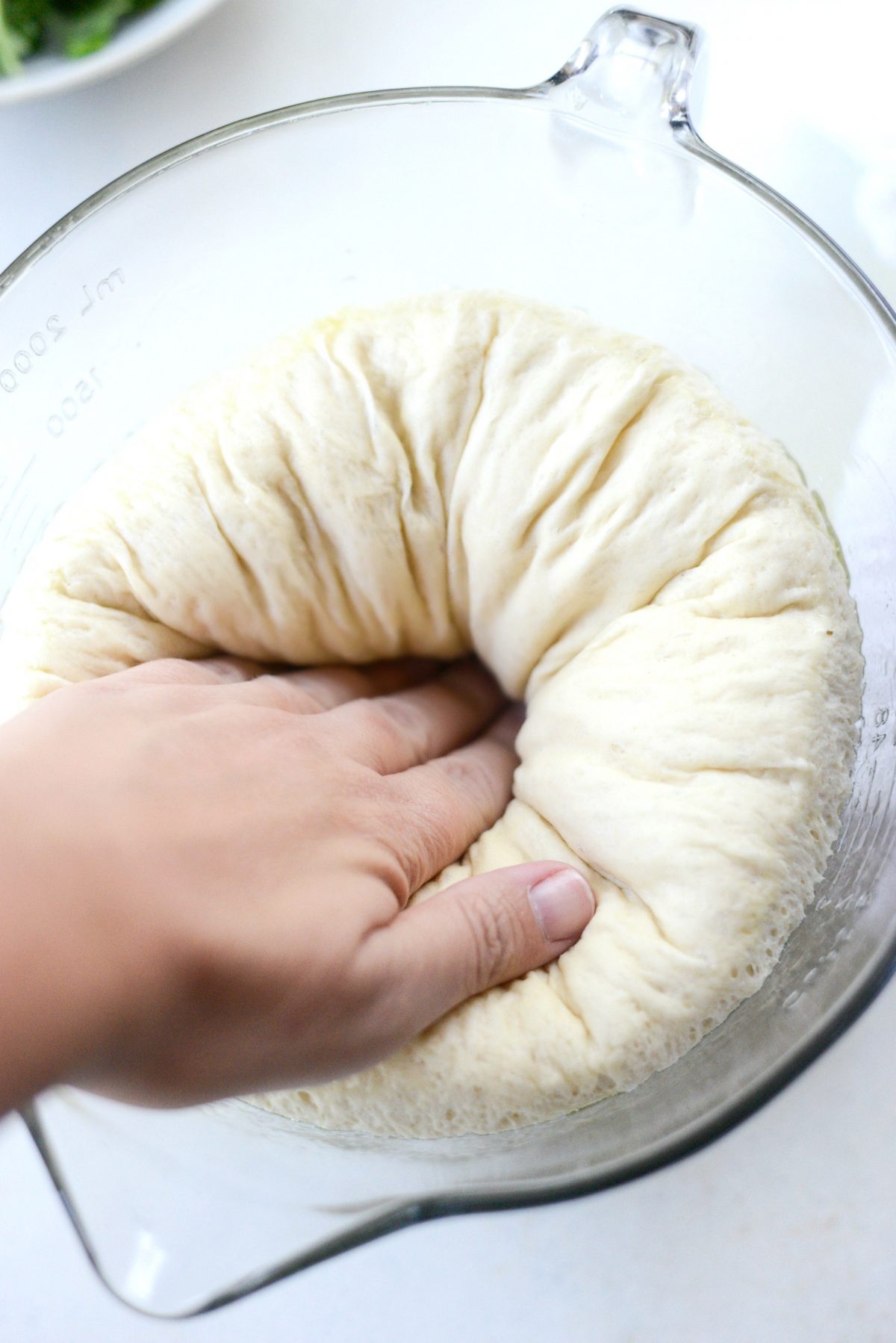 deflate the pizza dough