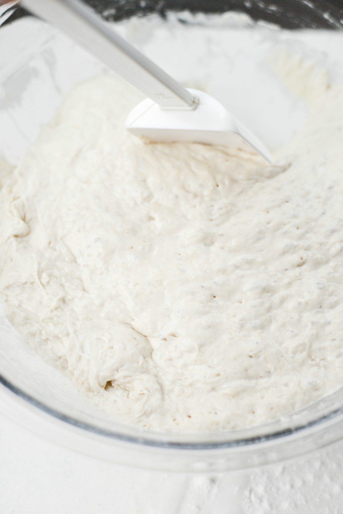 use a spatula to loosen the edges of the dough from the bowl.