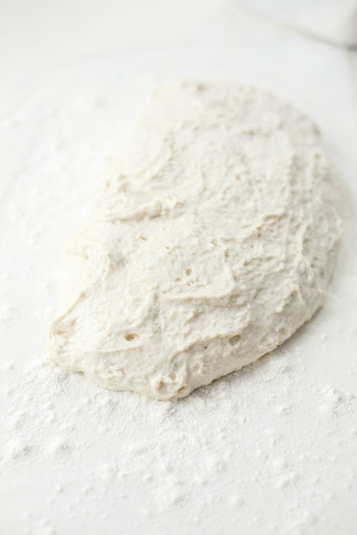dough on floured plastic wrap