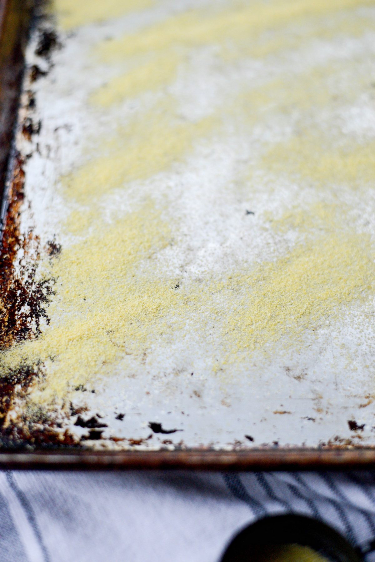 dust a sheet pan with cornmeal or semolina