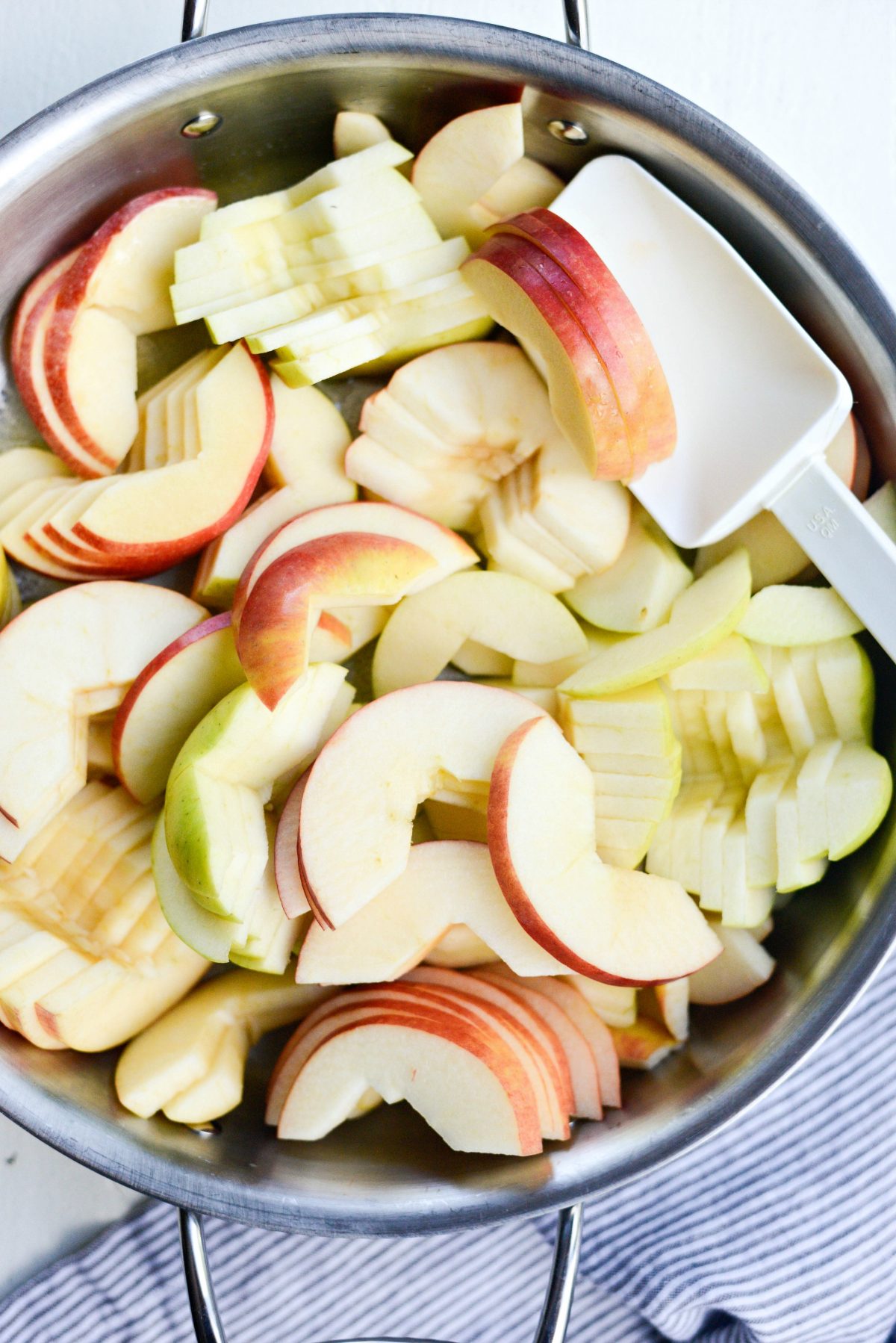 apples added to skillet with butter