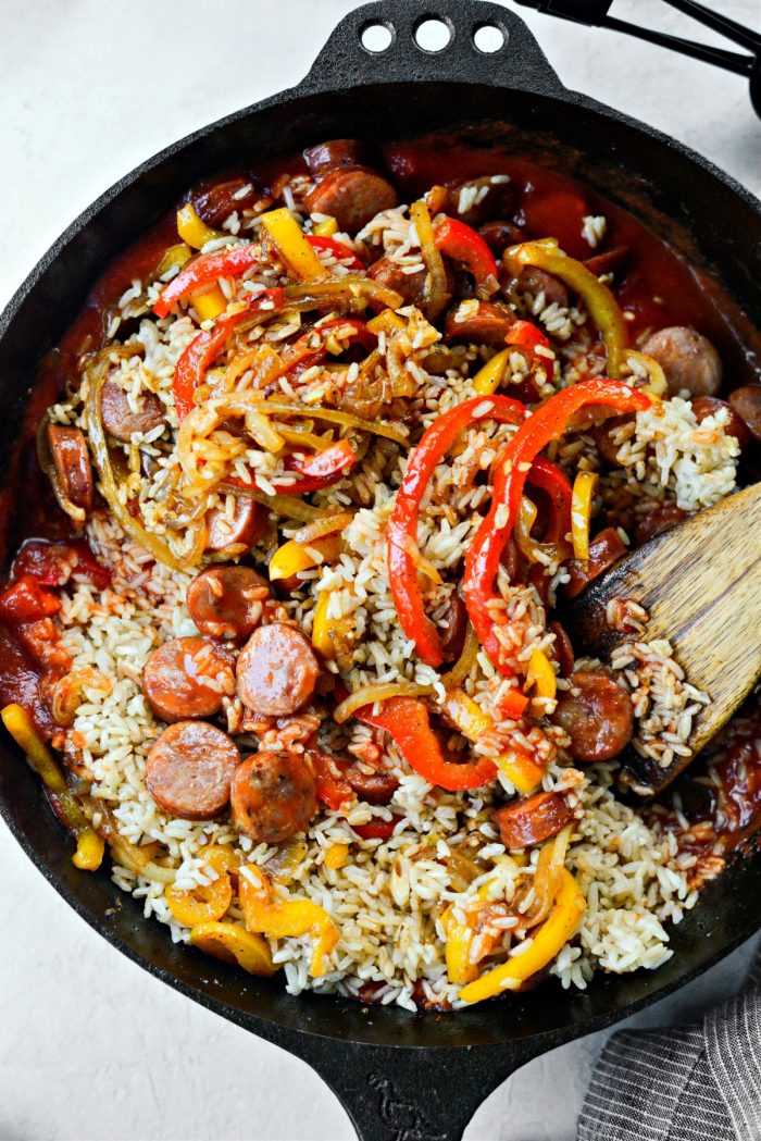 add peppers, onions and browned sausage with rice to the skillet.