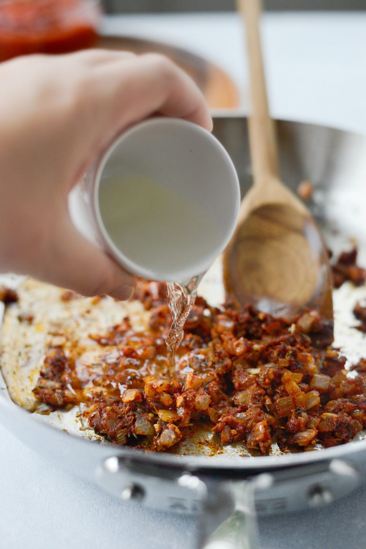 Pour in wine and deglaze the pan. 