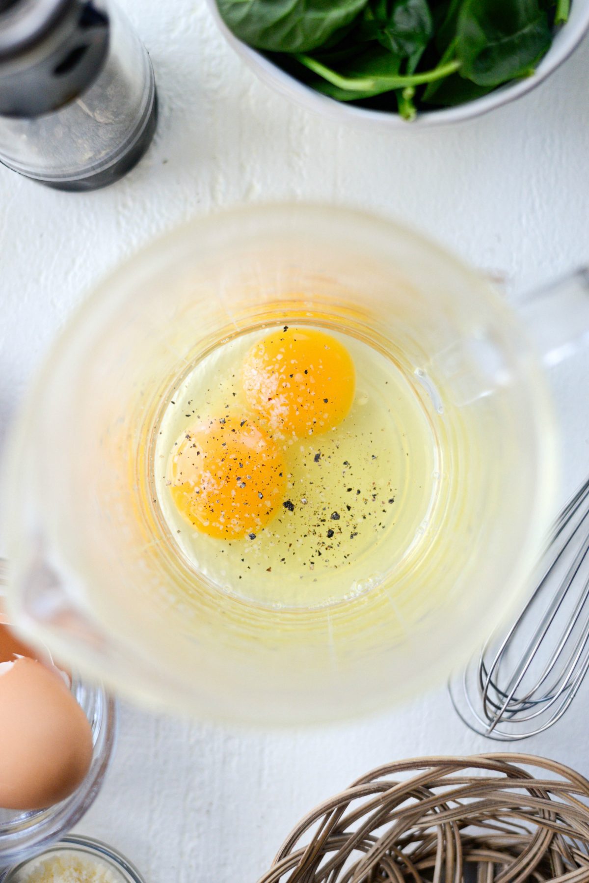 crack eggs into a bowl or liquid measuring cup and season
