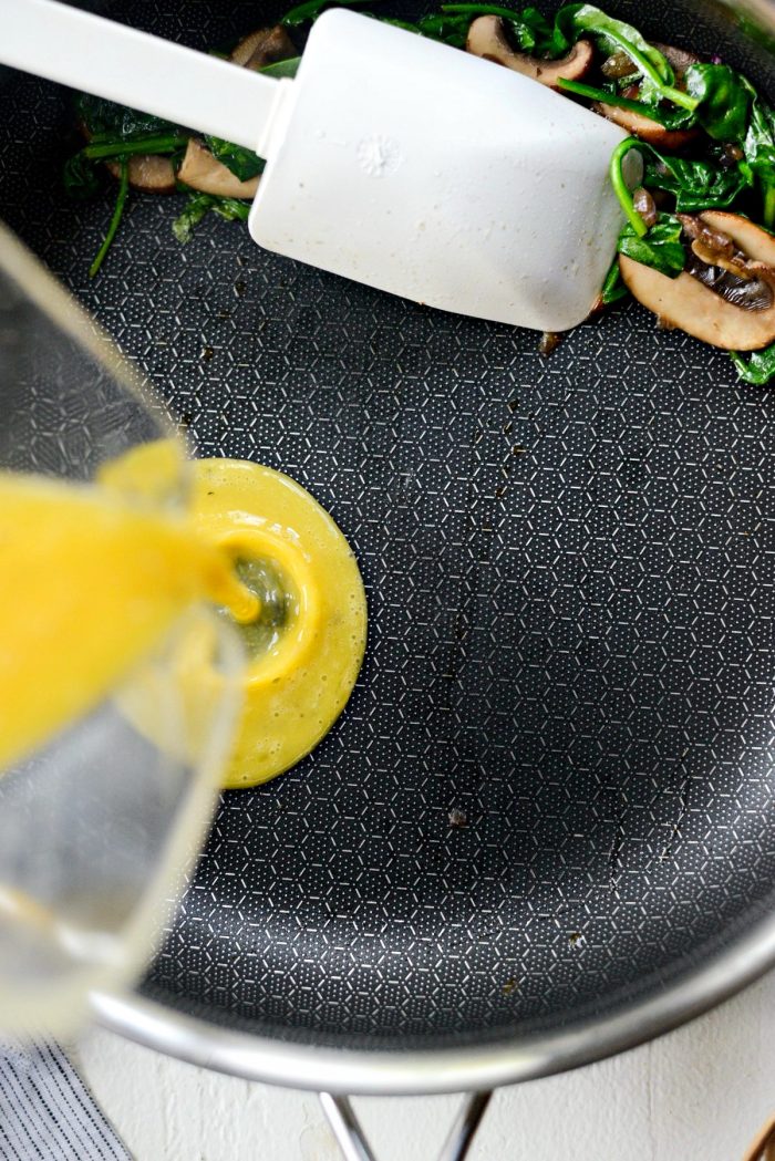 scoot veggies off to the side and pour in whisked eggs