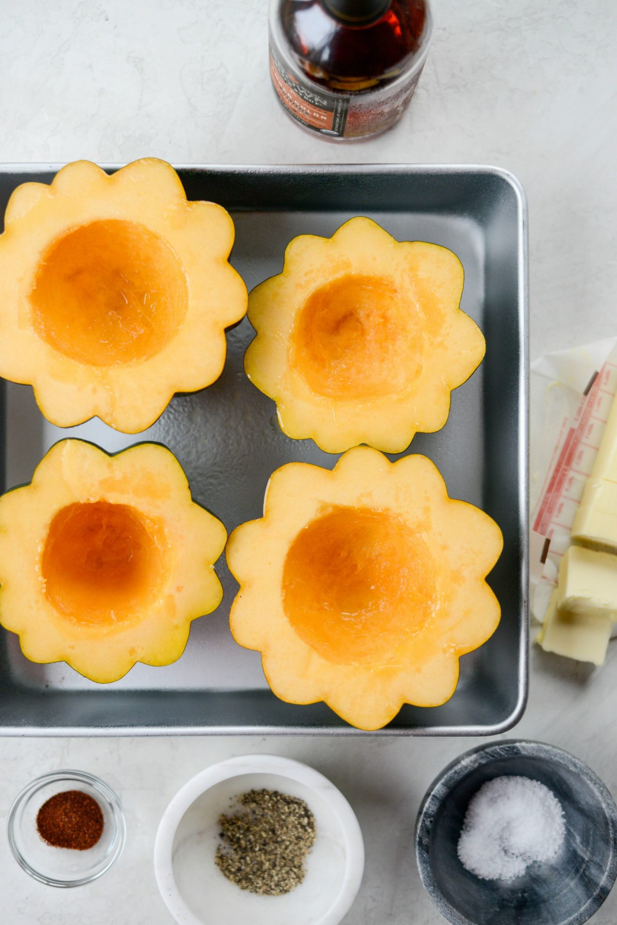 acorn squash halves in roasting pan