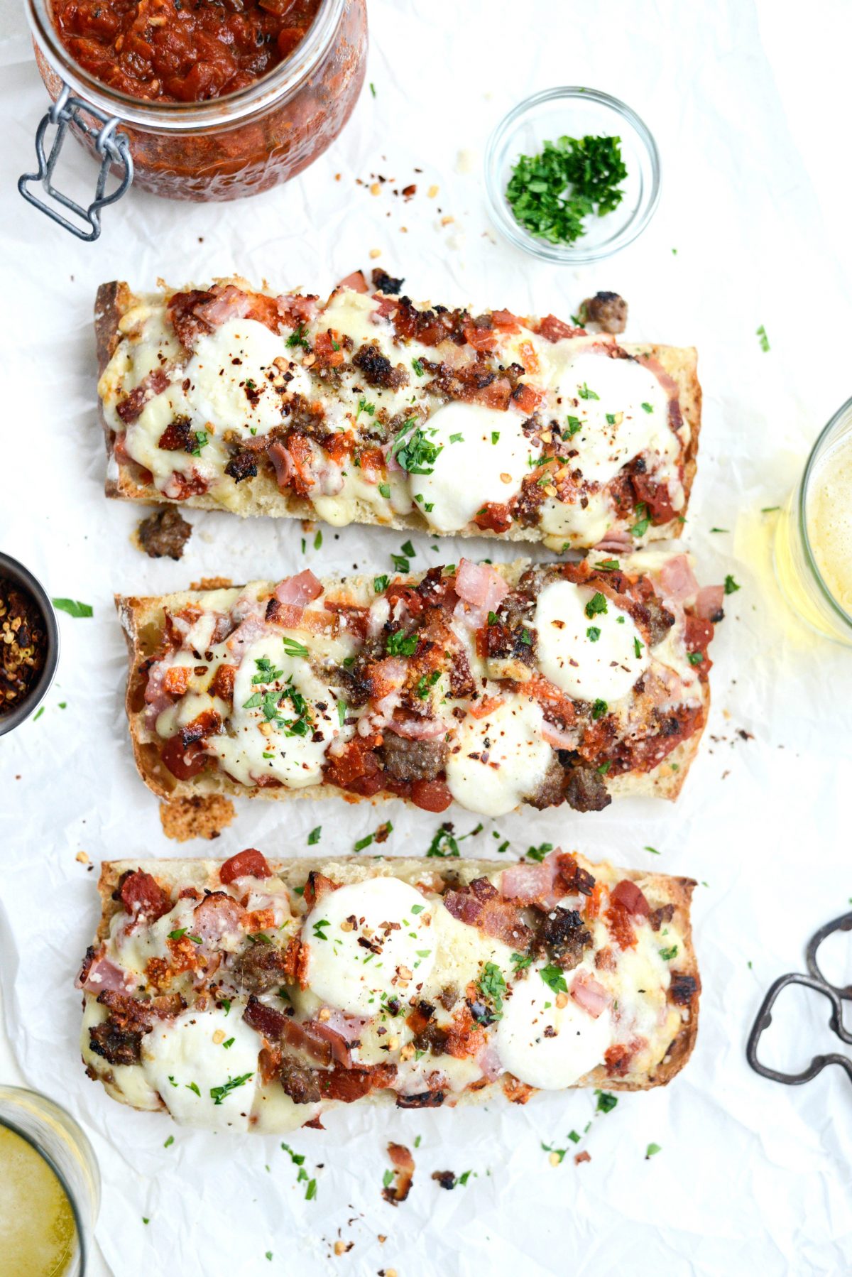 Meat Lovers Ciabatta Pizzas with Mozzarella Bombs sprinkled with pepper flakes and parsley