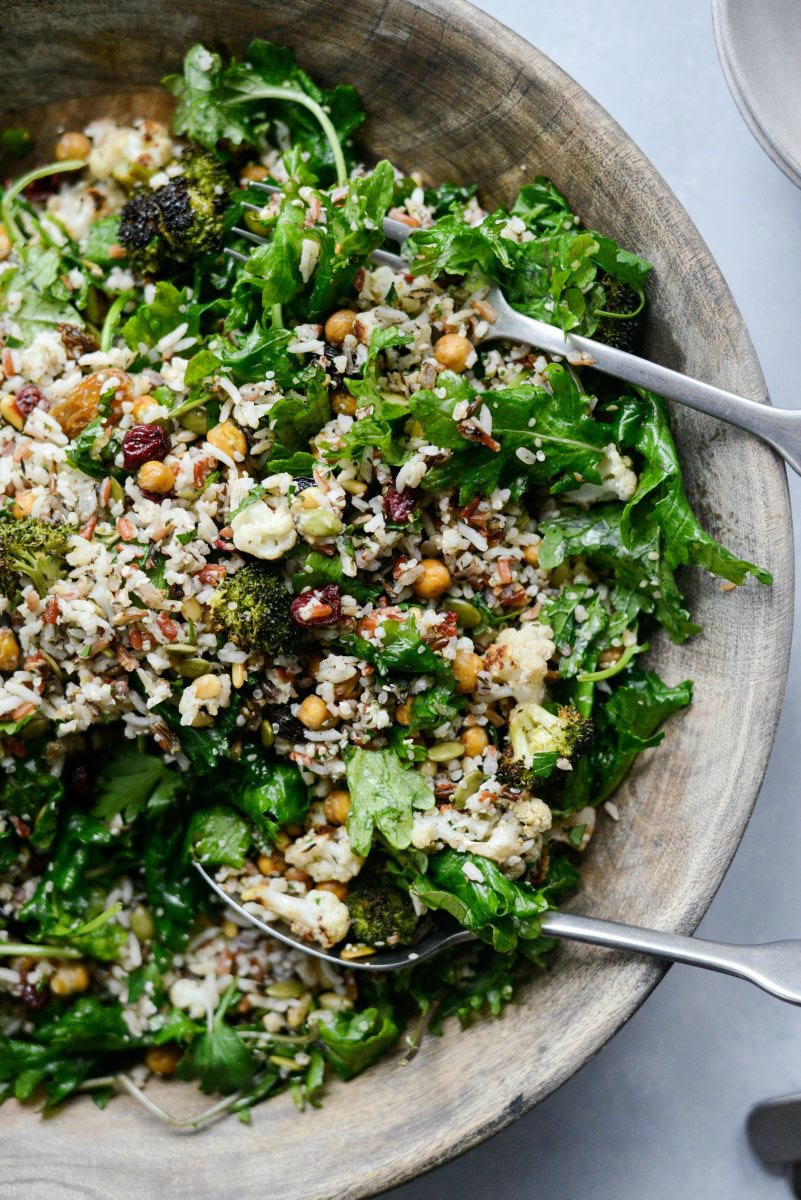 Roasted Broccoli Cauliflower Kale Salad with serving spoons.