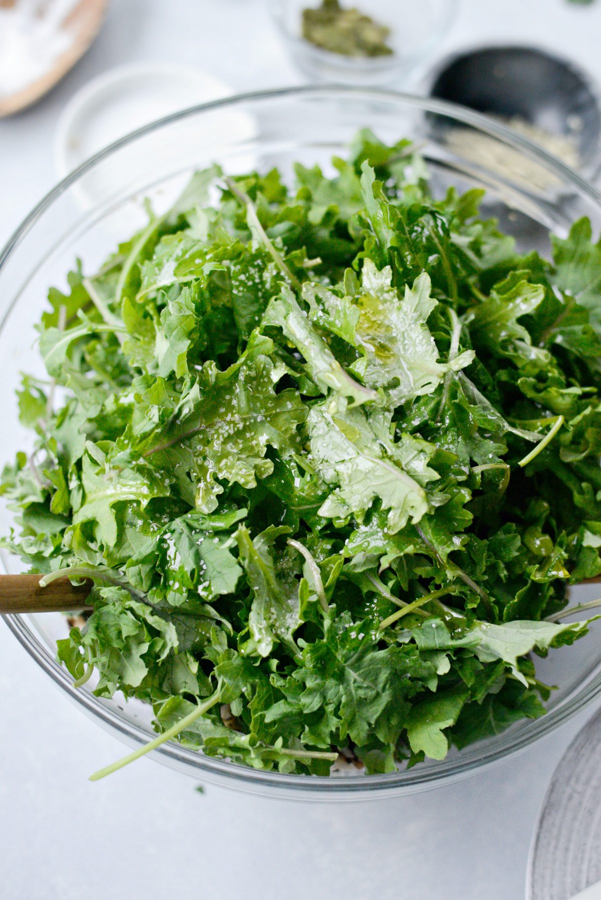 bay kale, lemon juice, olive oil and salt added to the bowl.