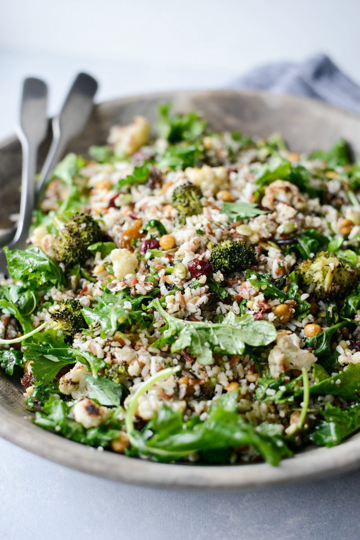 Roasted Broccoli Cauliflower Kale Salad in wooden bowl.