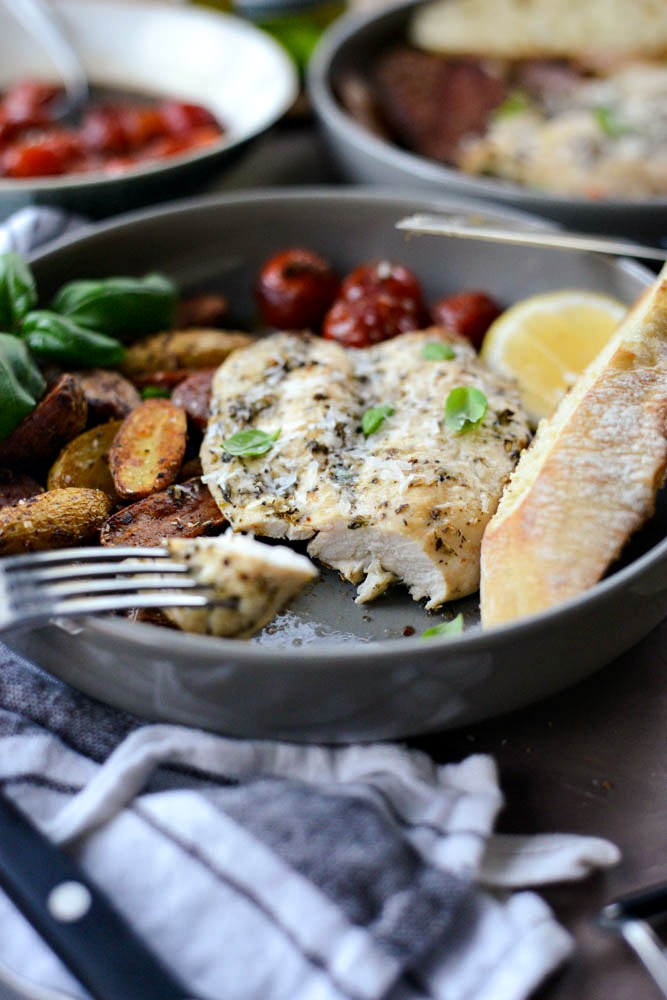 forkful of Tuscan Chicken and Potato Sheet Pan Dinner with Balsamic Burst Tomatoes