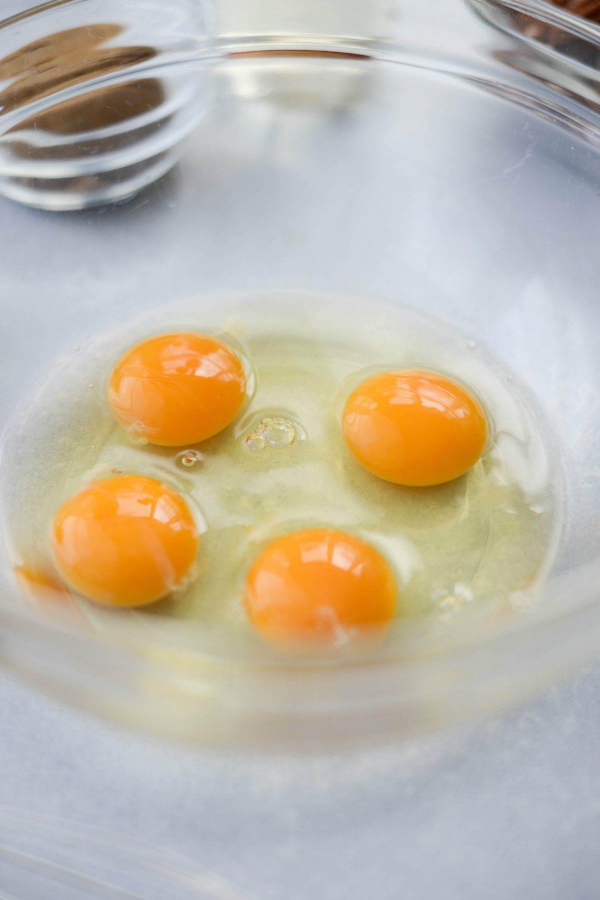 crack and add 4 eggs to a mixing bowl.