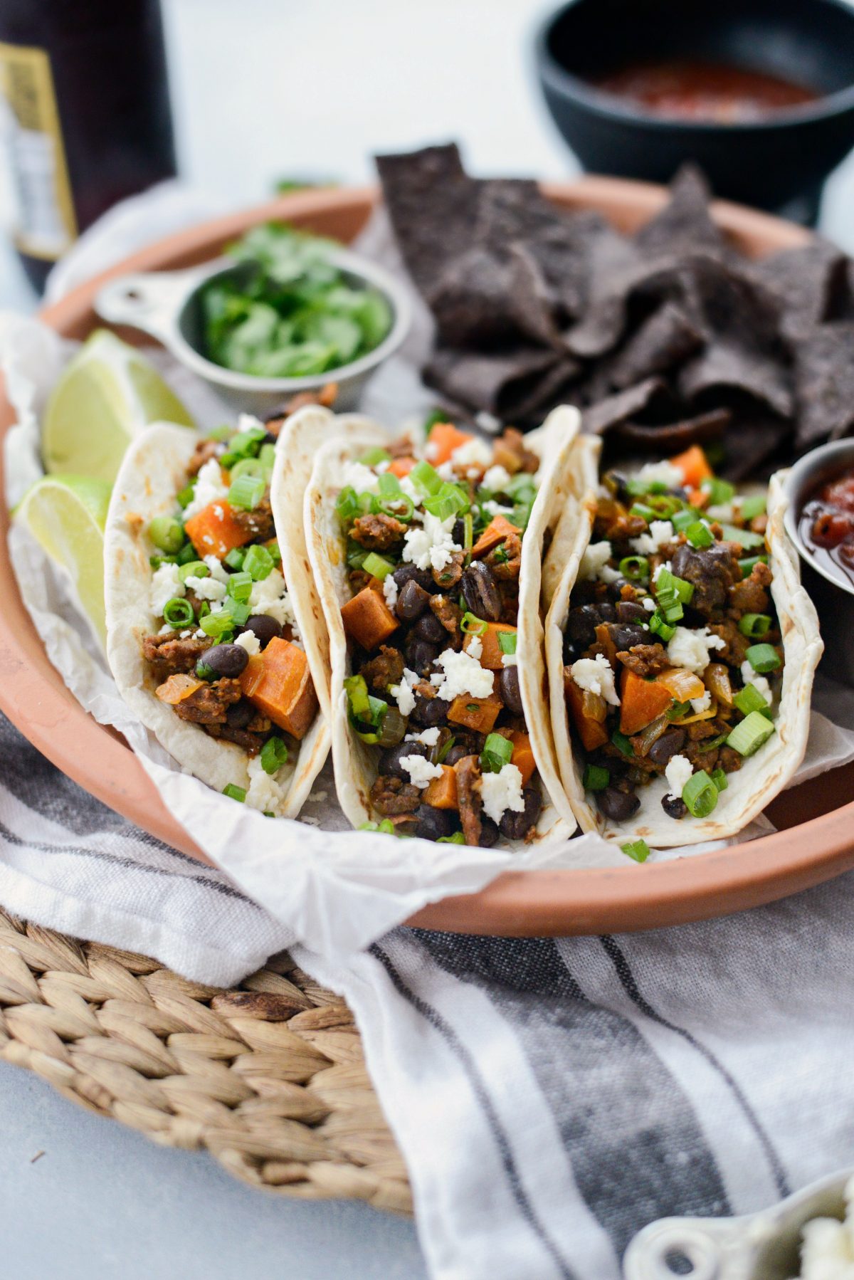 Chorizo Sweet Potato Black Bean Tacos with crumbled queso fresca and green onions 