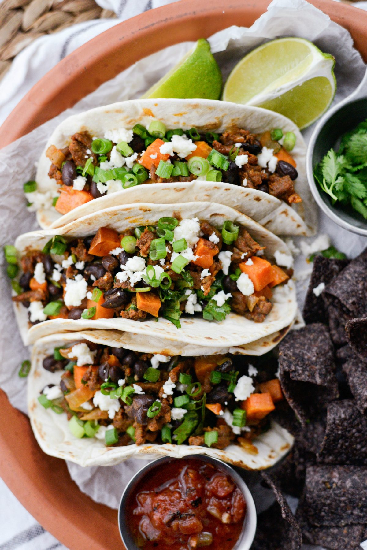 Chorizo Sweet Potato Black Bean Tacos topped with green onions.