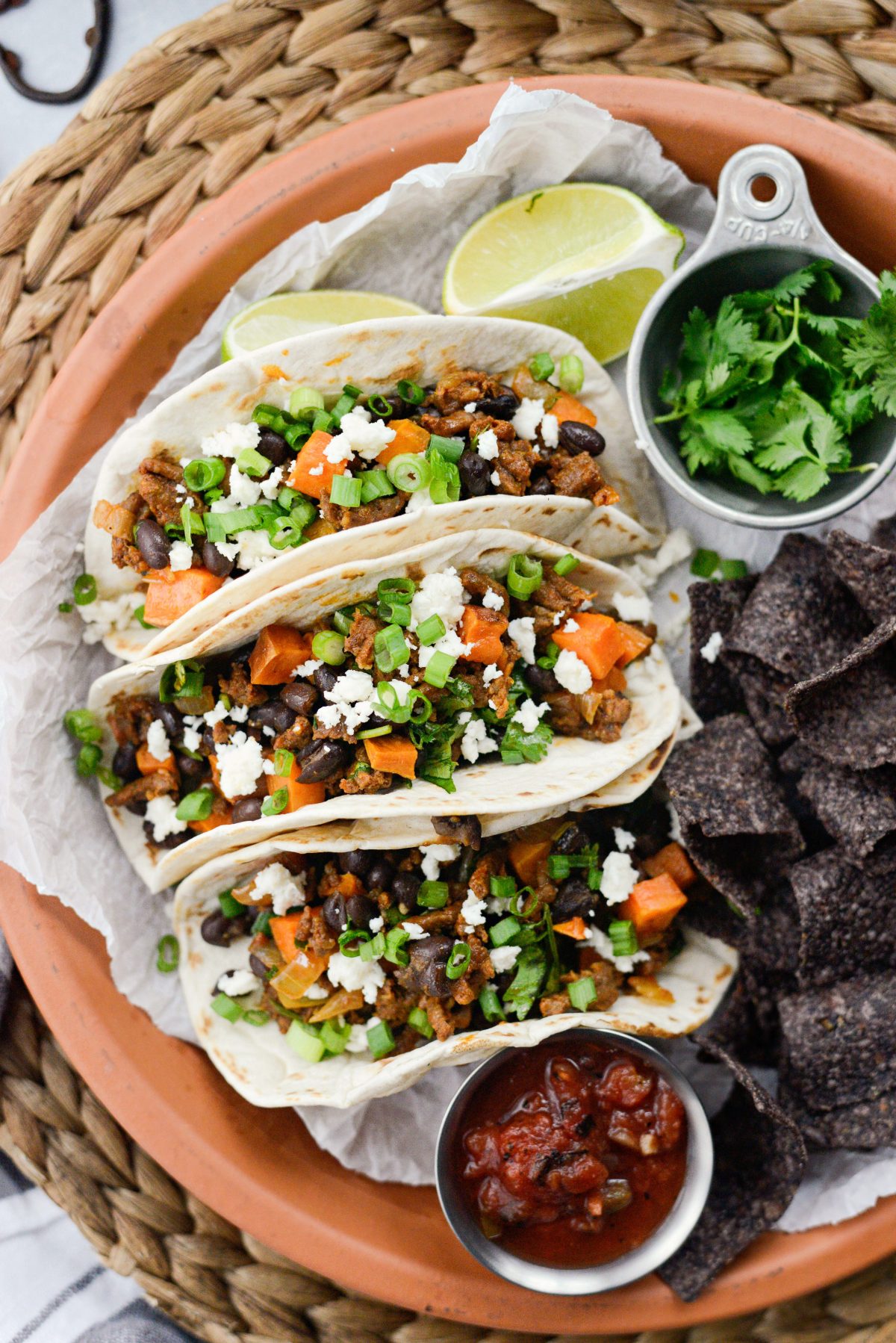 Chorizo Sweet Potato Black Bean Tacos on a terra-cotta plate.