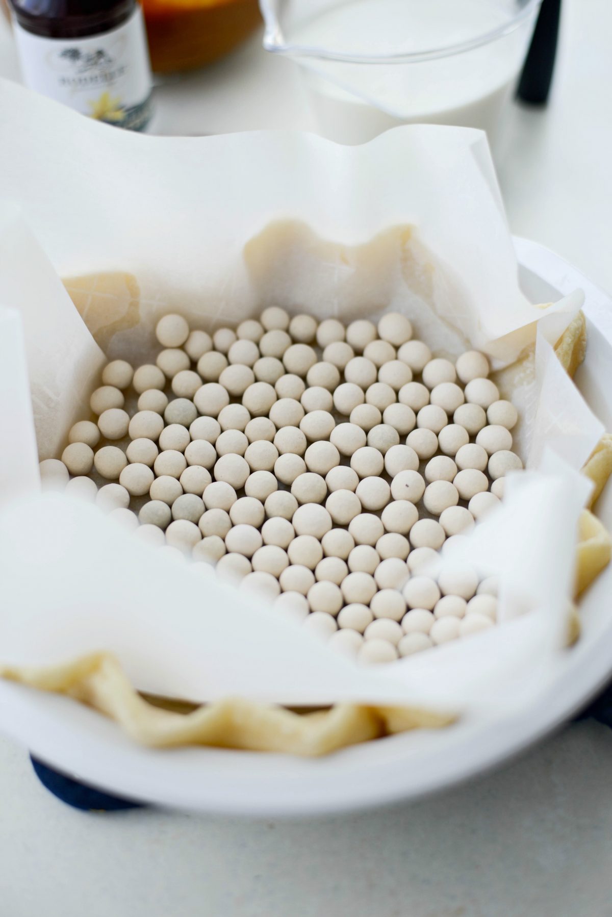 line with parchment and fill with pastry weights or dried beans.