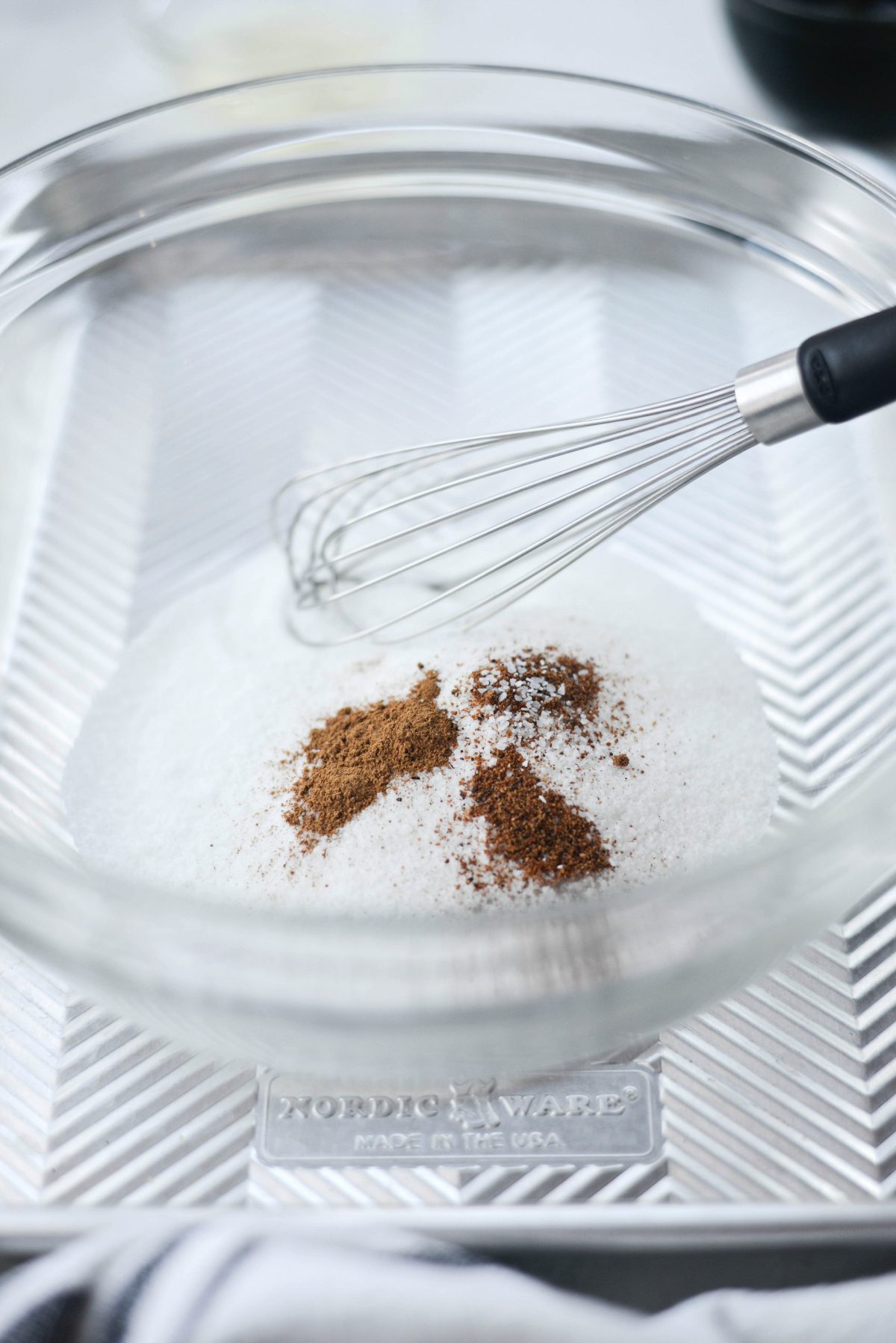 sugar and spices in a bowl with whisk