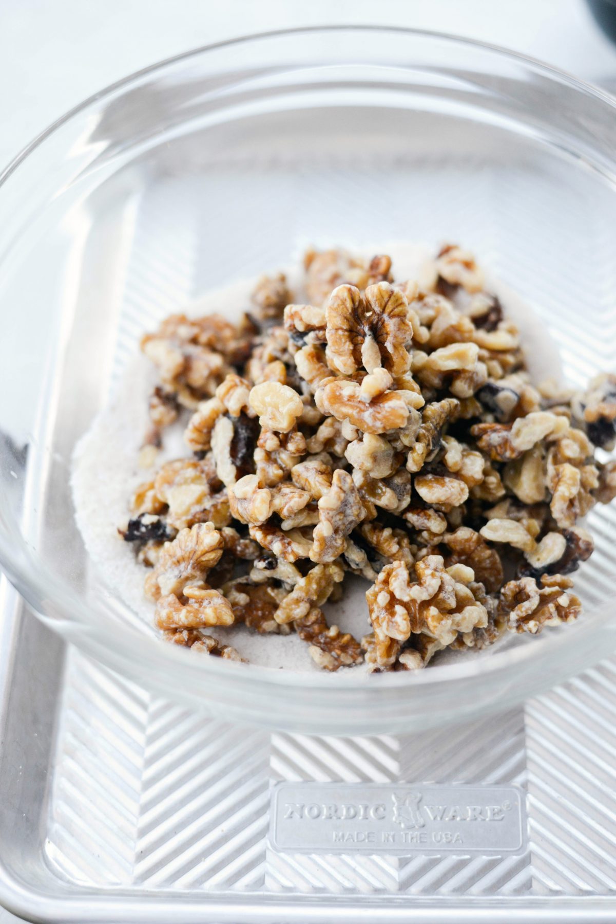 add coated walnuts to bowl with sugar and spices