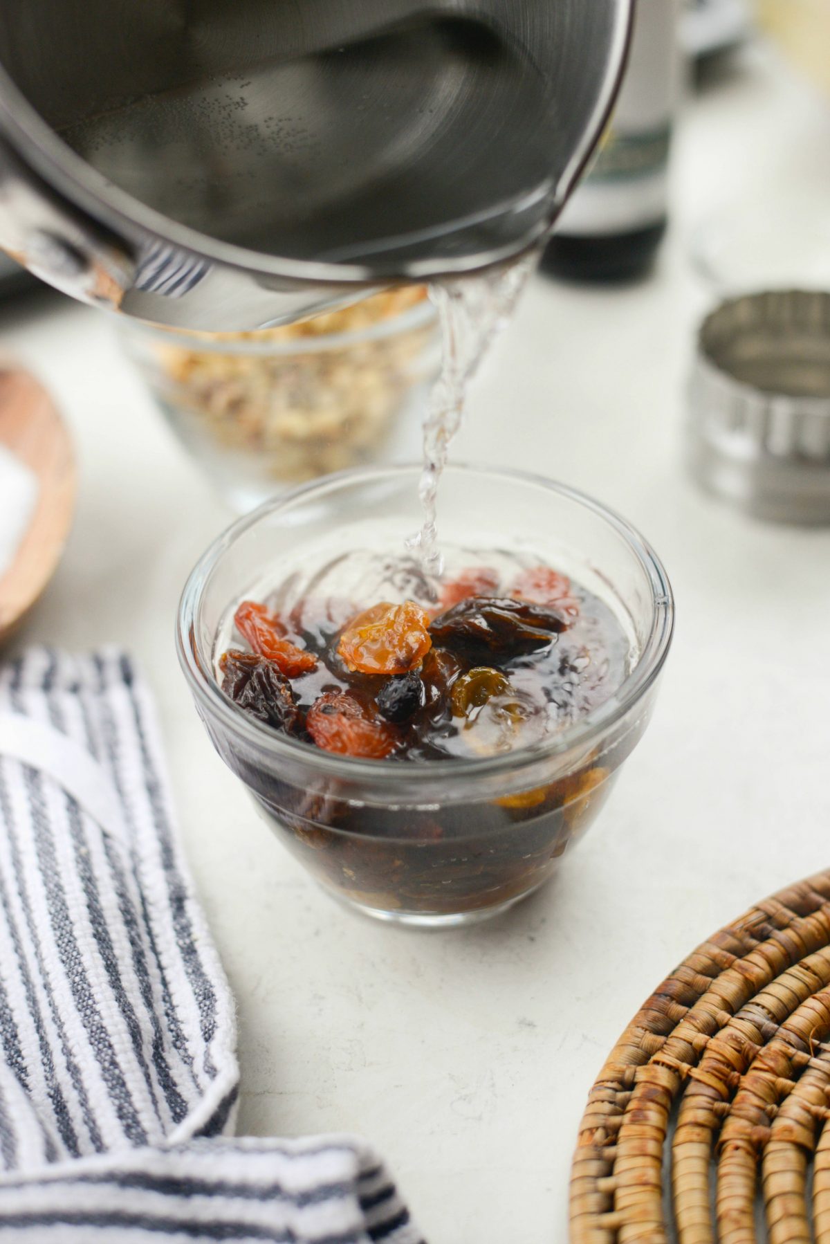 pouring hot water into bowl with raisins