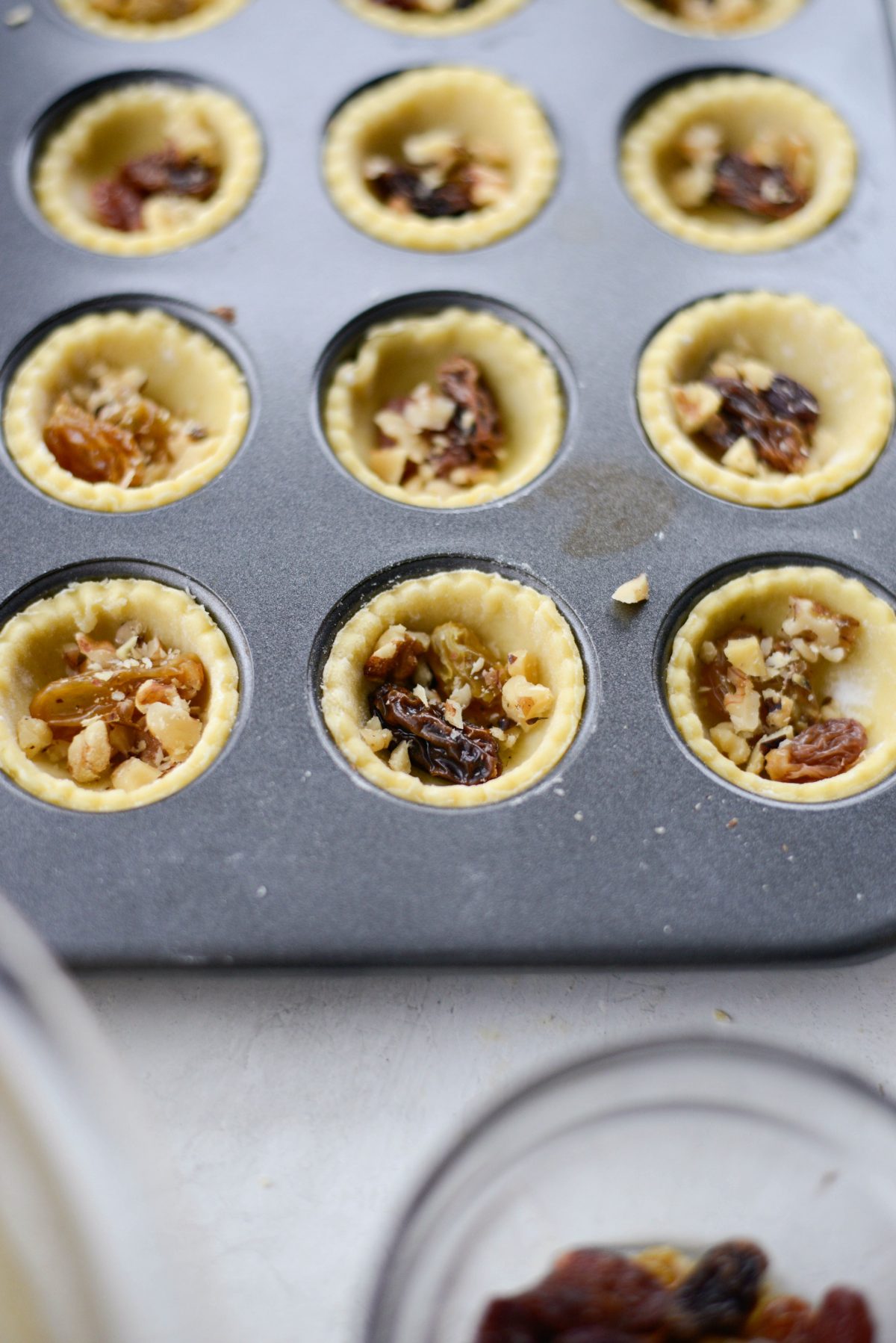 add raisins and chopped walnuts to each shell