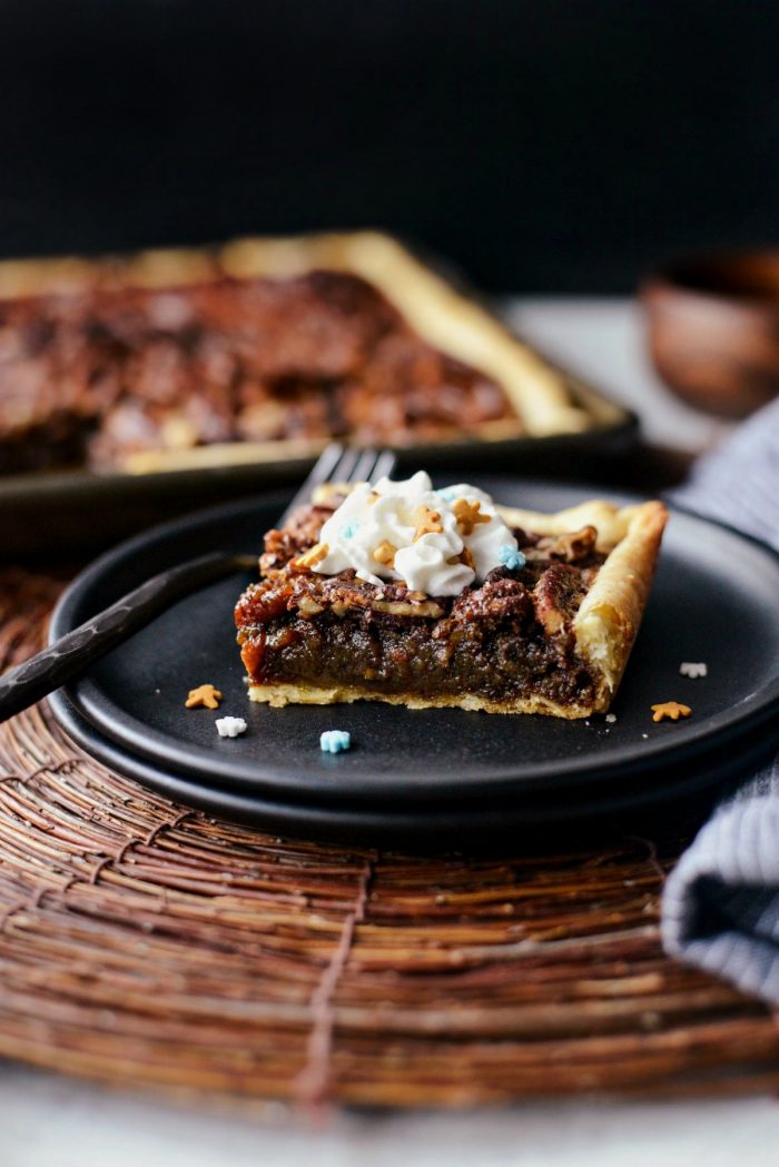 Gingerbread Pecan Slab Pie on plate with whipped cream