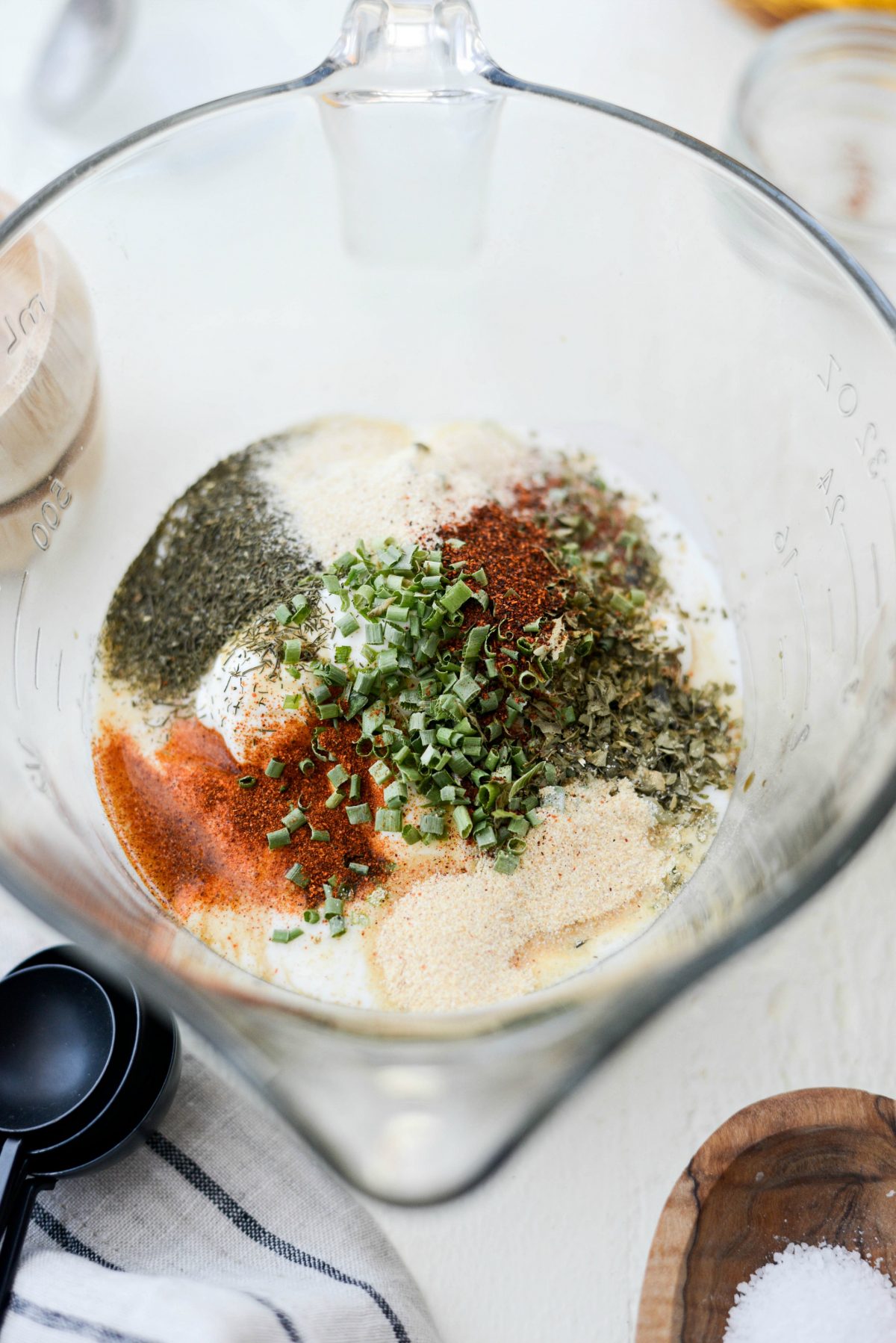 Greek Yogurt Ranch Dressing ingredients measure and added to a bowl