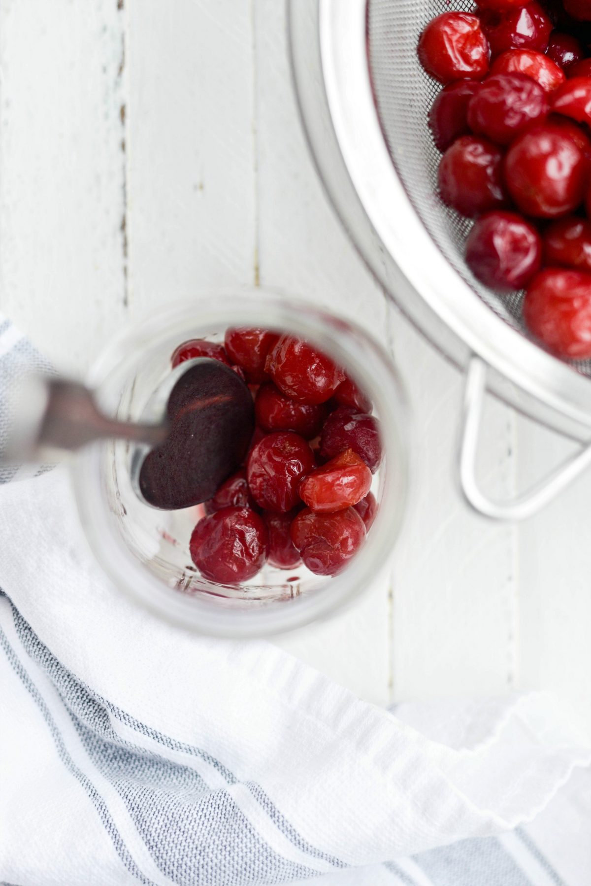 spoon cherries into a large jar or two jars