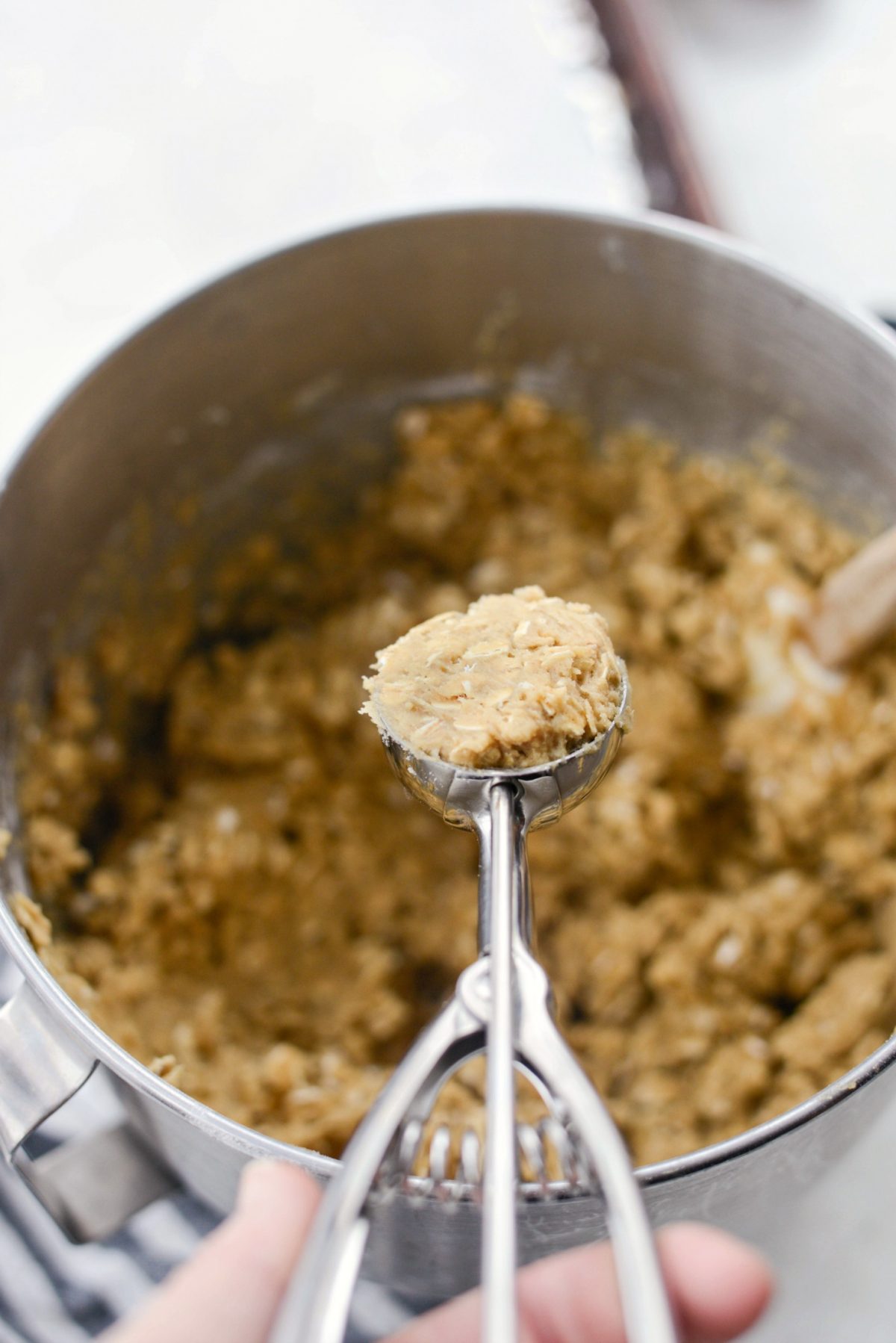 measuring a scoop of cookie dough