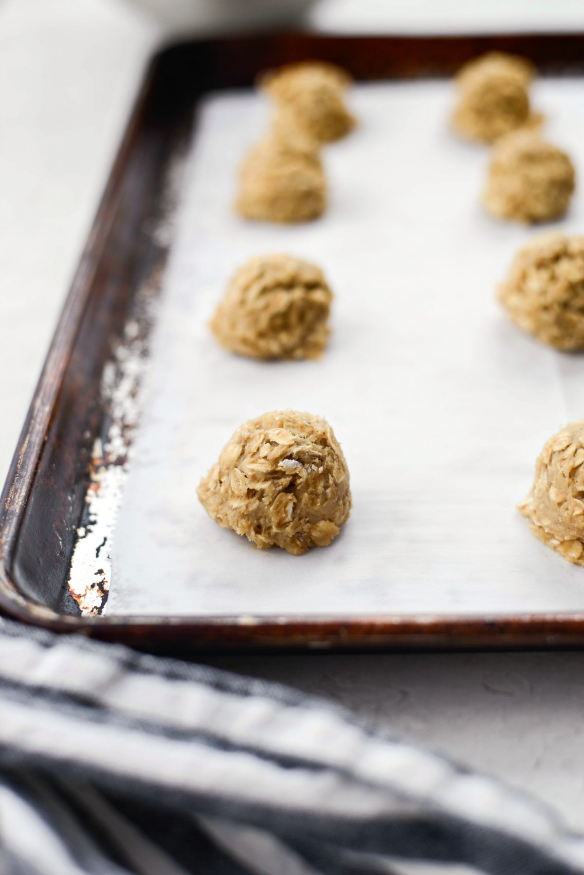 mounds of cookie dough on lined baking sheet.