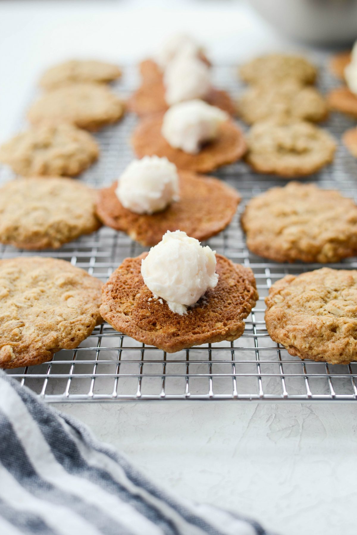 inverted cookies topped with a small scoop of buttercream.