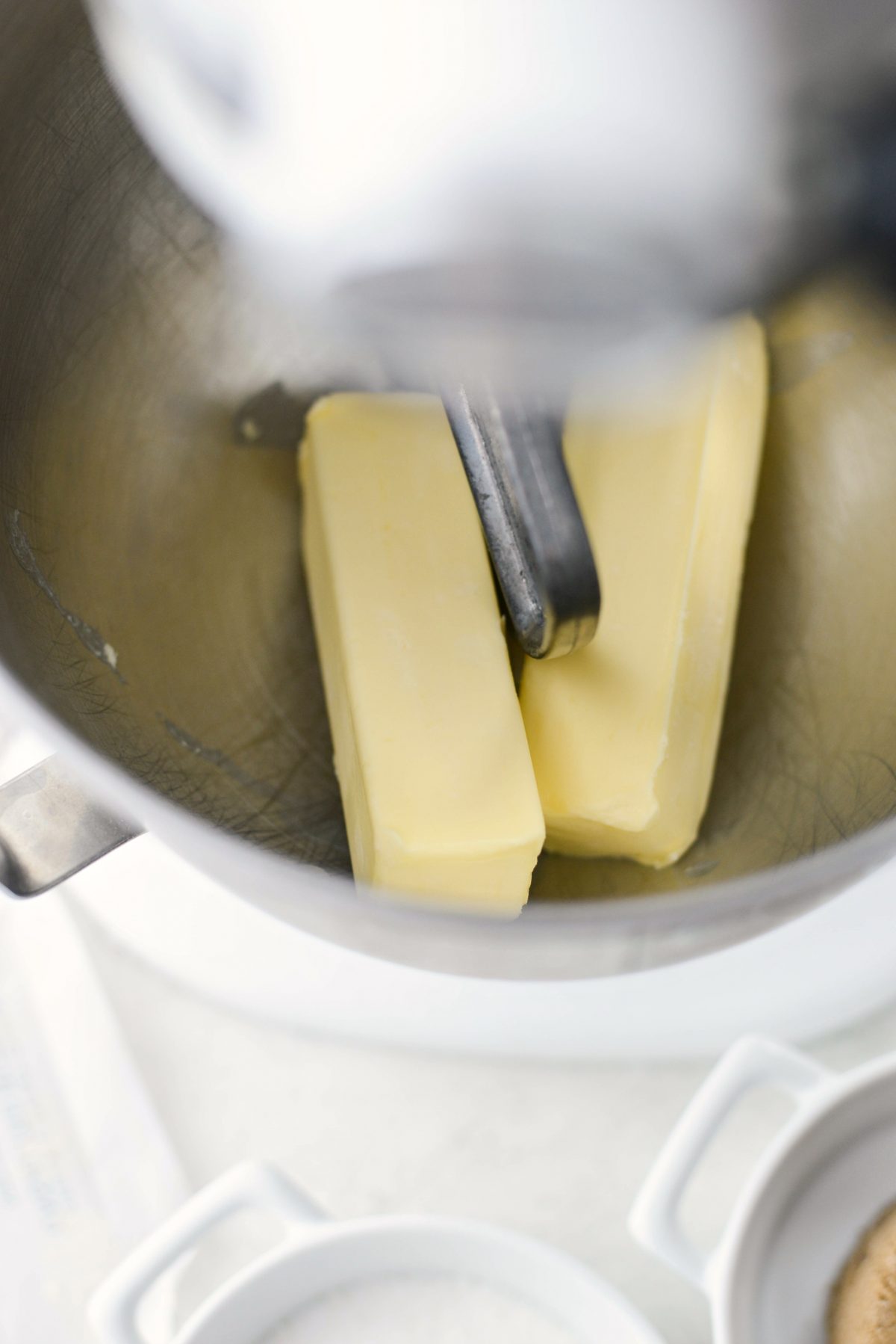 softened butter in mixer.