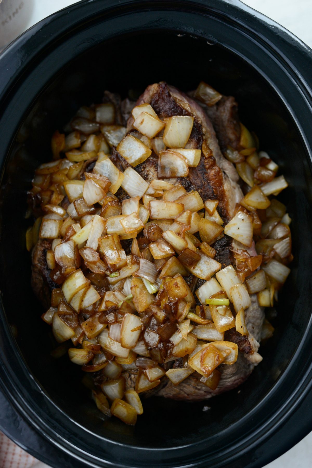 add onions to beef in slow cooker