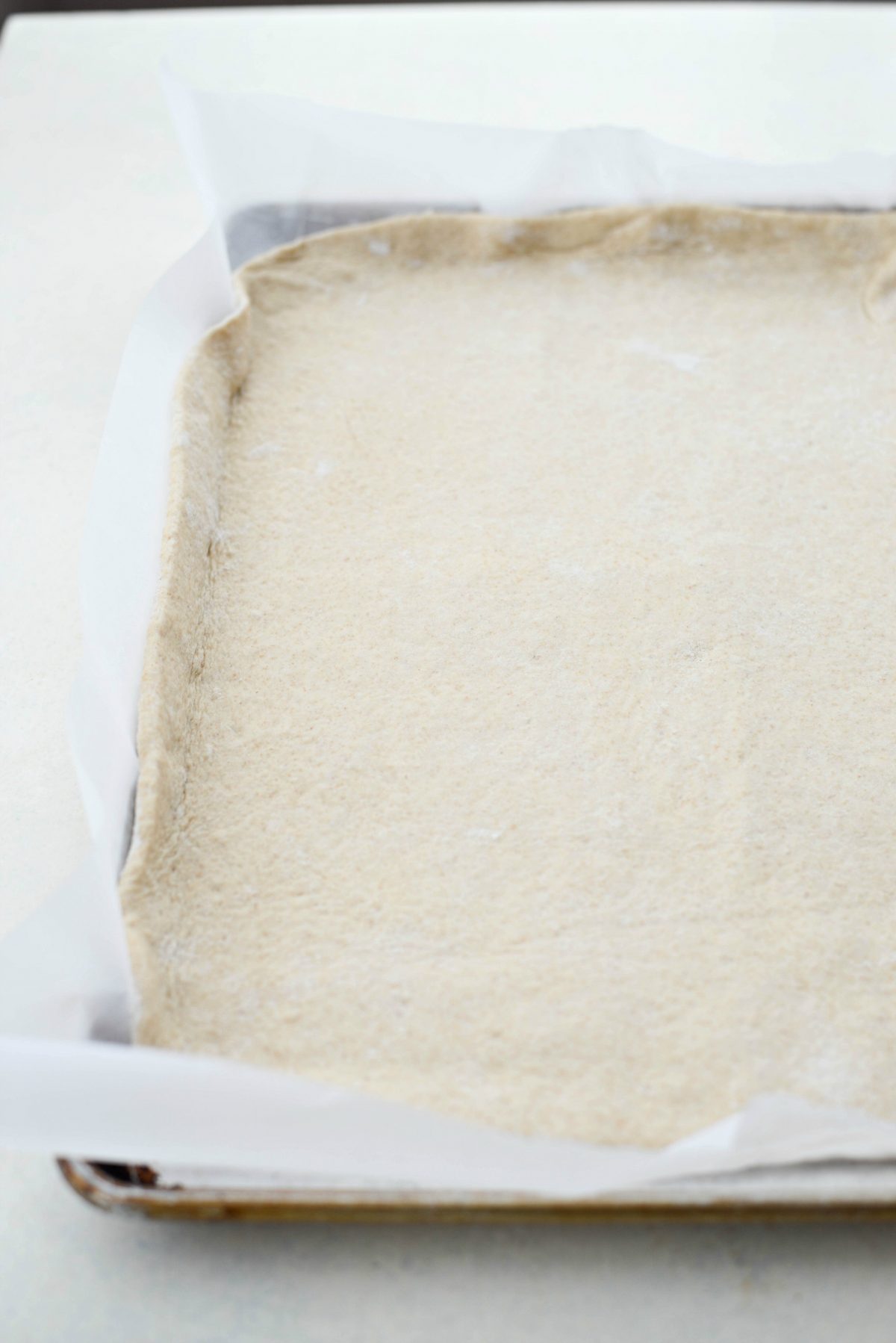 transfer the dough to parchment paper placed in a rimmed baking sheet