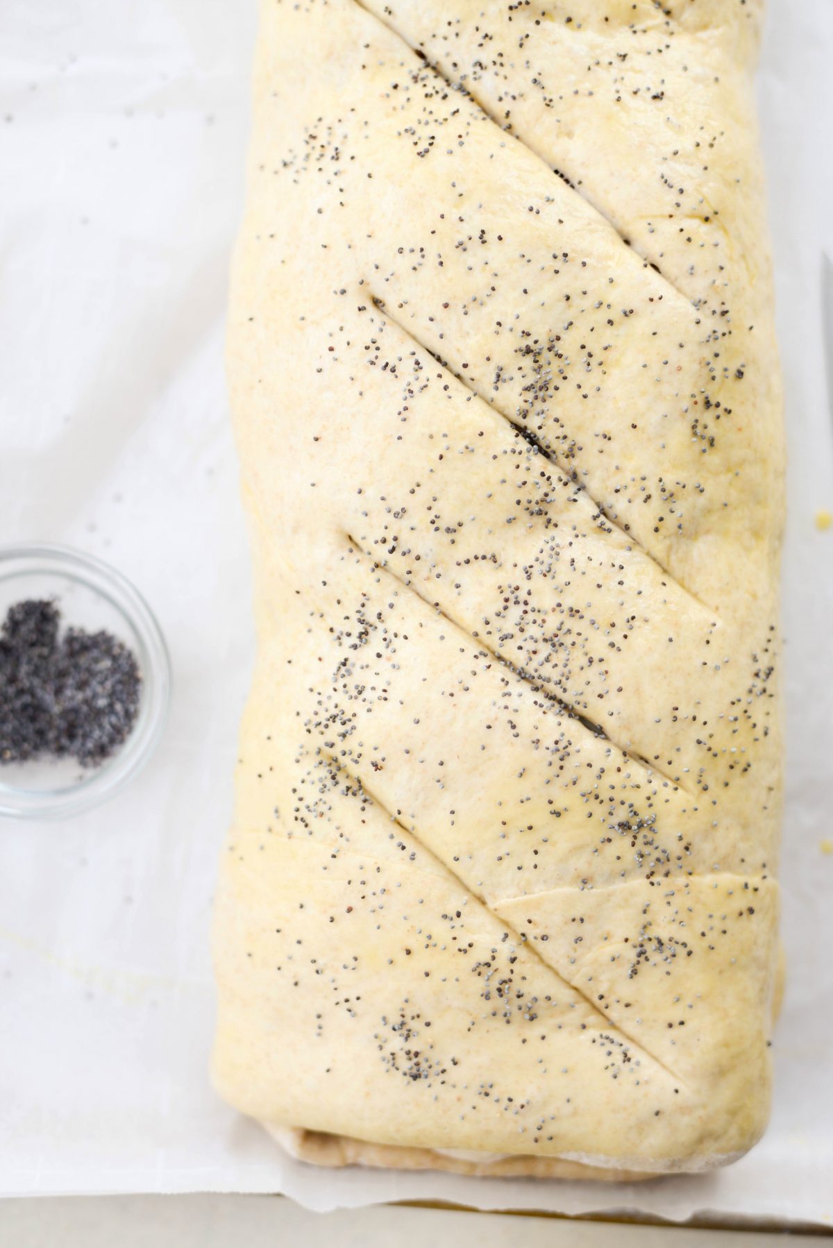 cut vents and sprinkle with poppy seeds