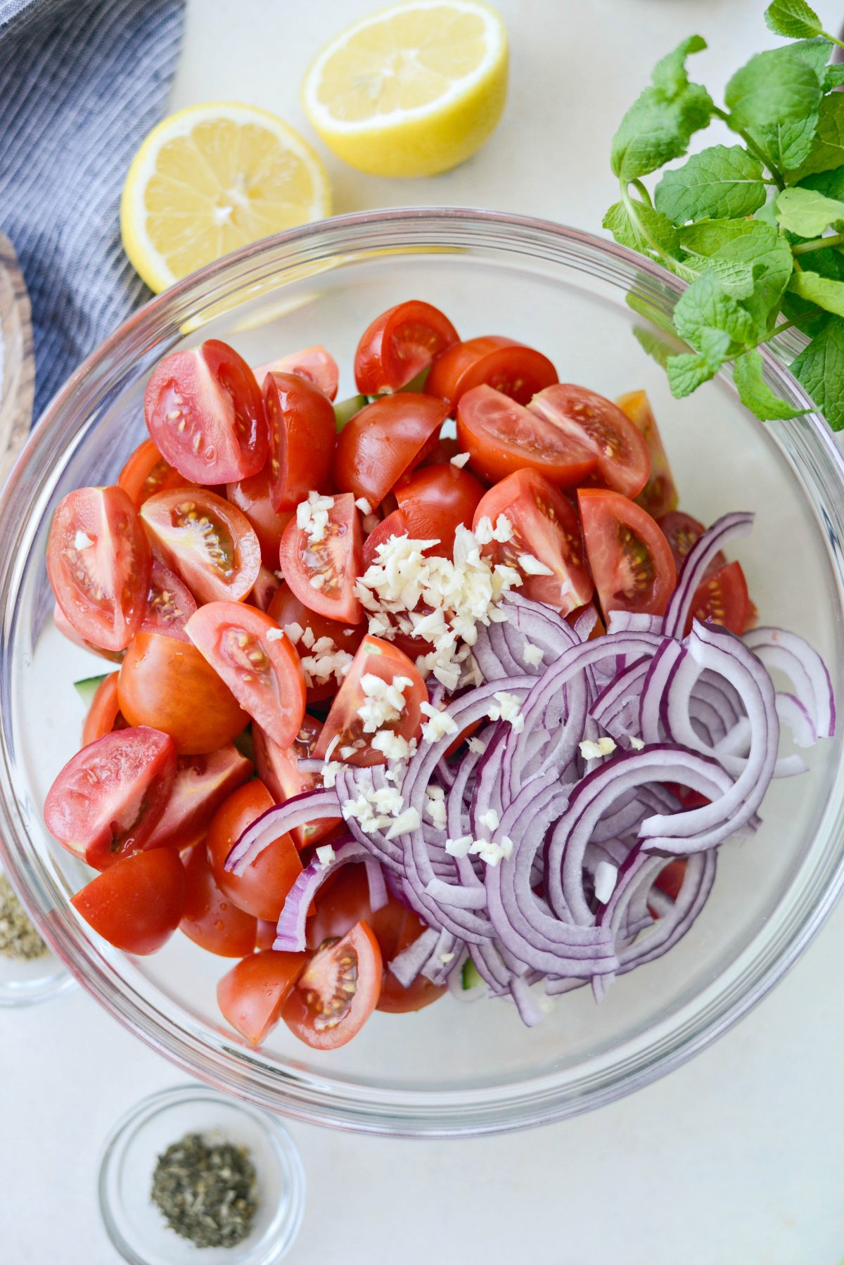 add quartered tomatoes, sliced red onion and minced garlic to the same bowl.
