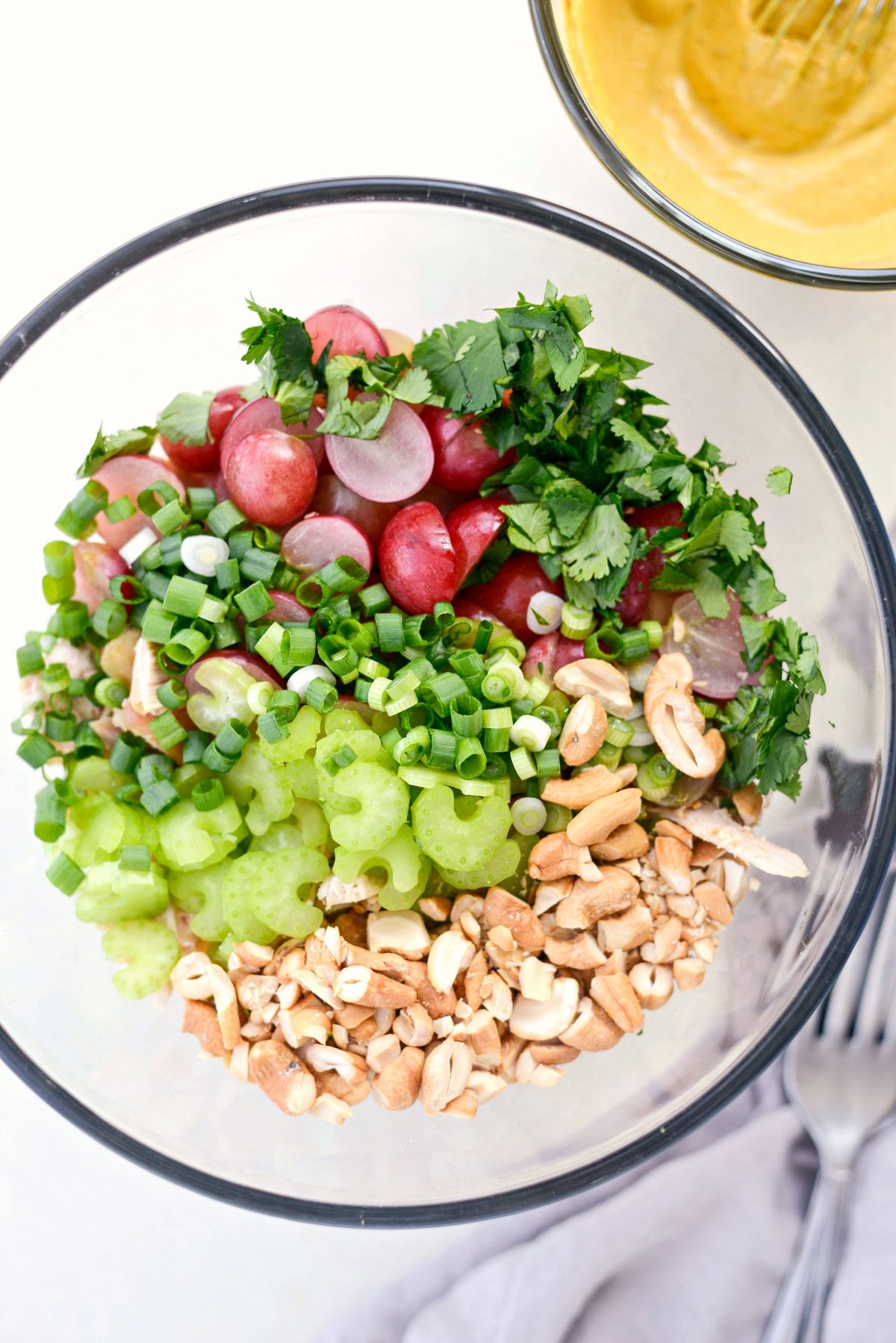 Add chicken, grapes, celery, green onion, cilantro and cashews to a bowl