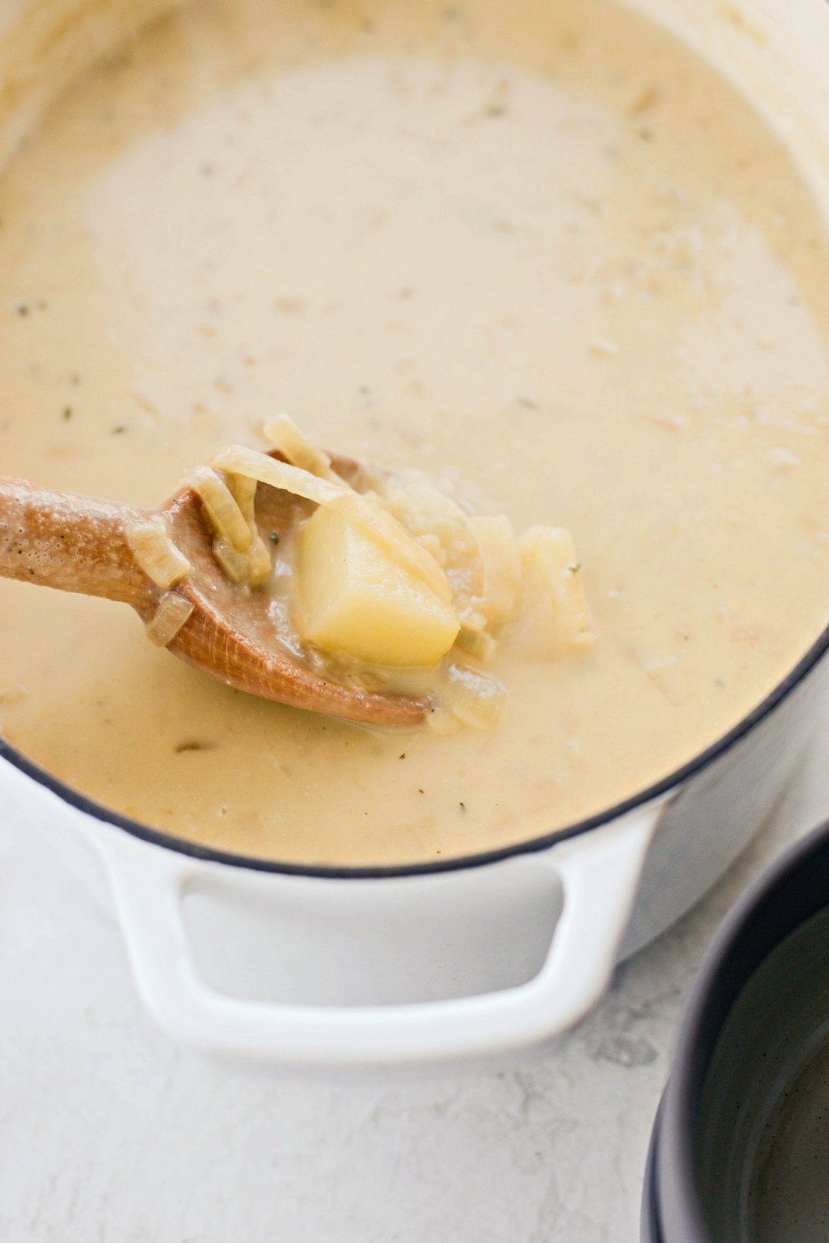 tender potato and caramelized onions on spoon.