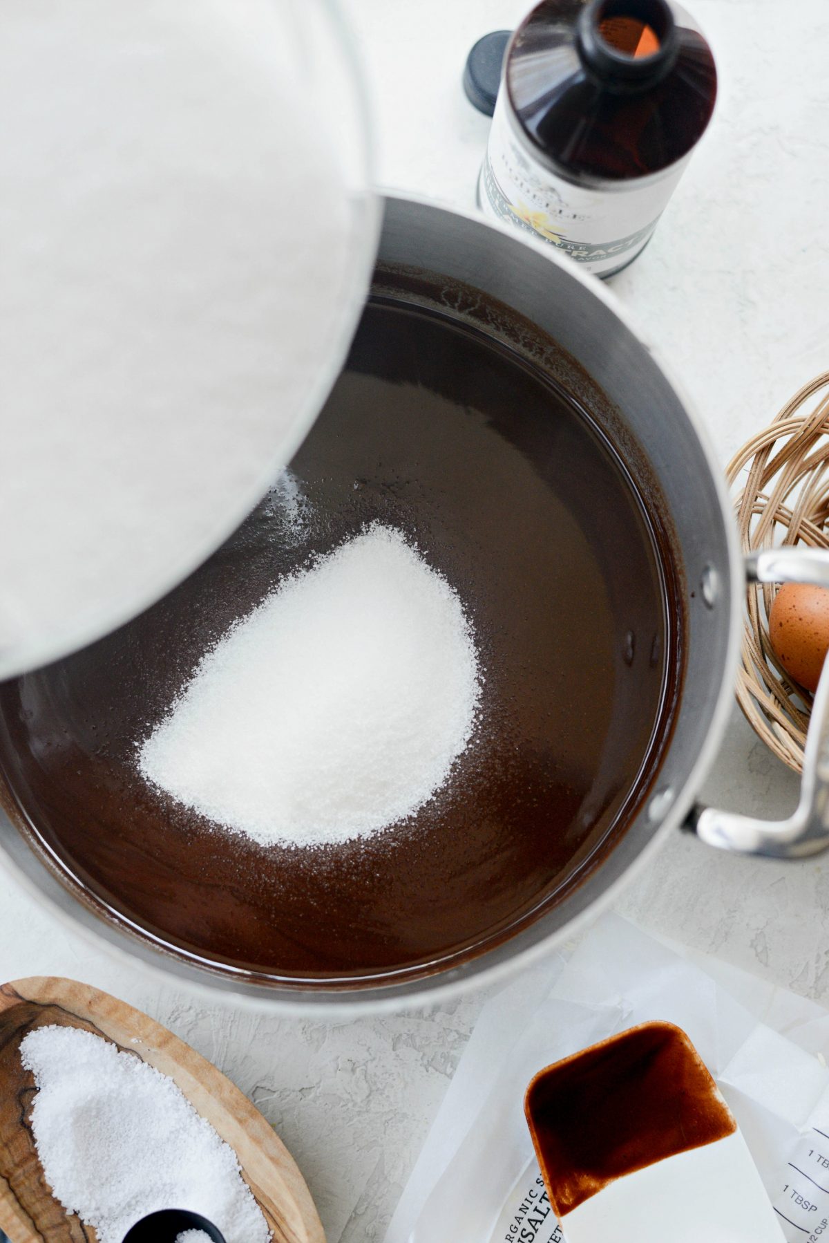 adding sugar to chocolate mixture