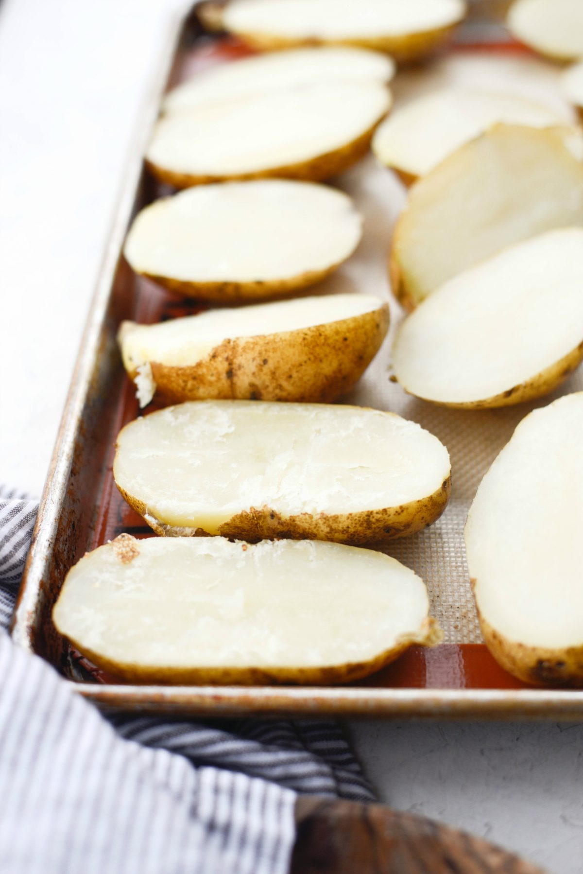 halved potatoes on a sheet pan