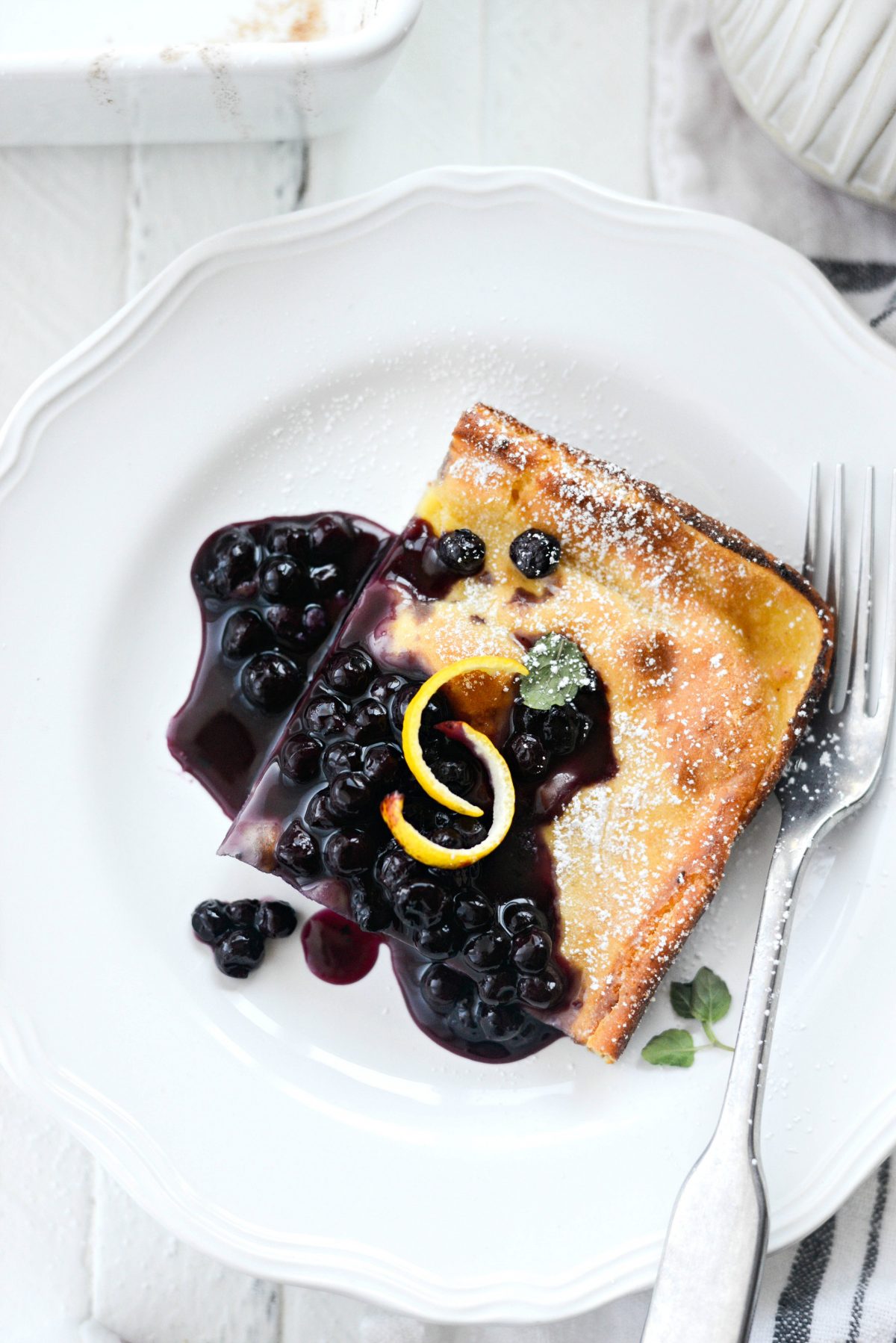 slice of Lemon Ricotta Puff Pancake with wild blueberry syrup