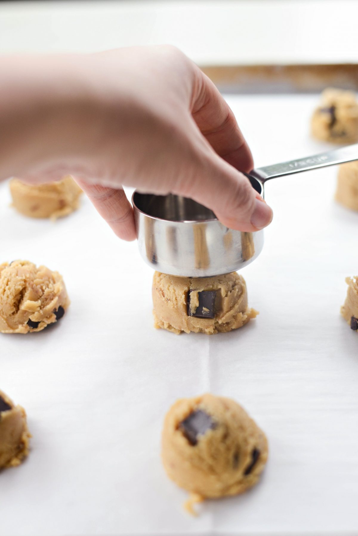 flatten with the flat side of a measuring cup.