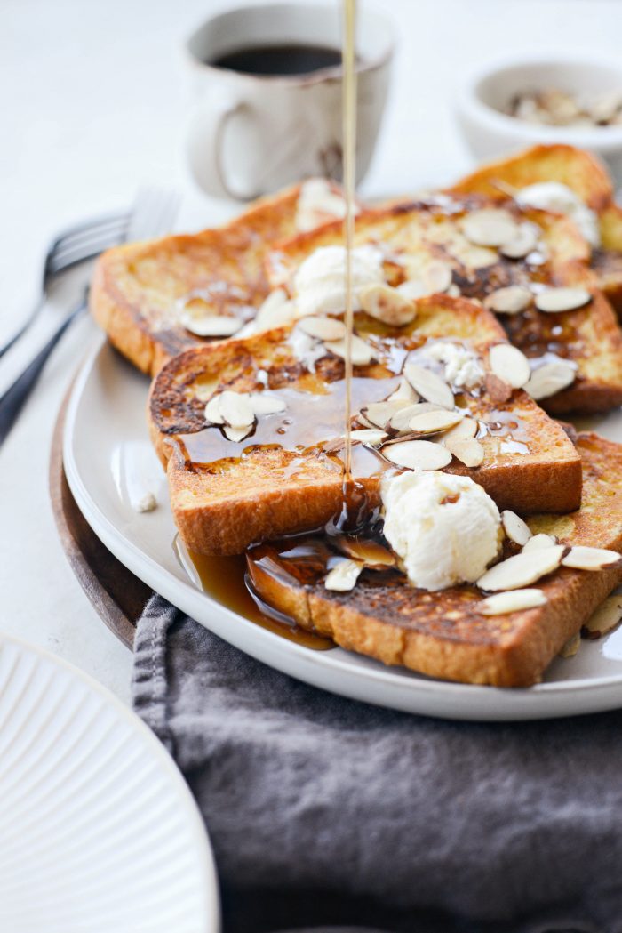 plate Vanilla Cardamom French Toast and top with butter, sliced almonds and real maple syrup.